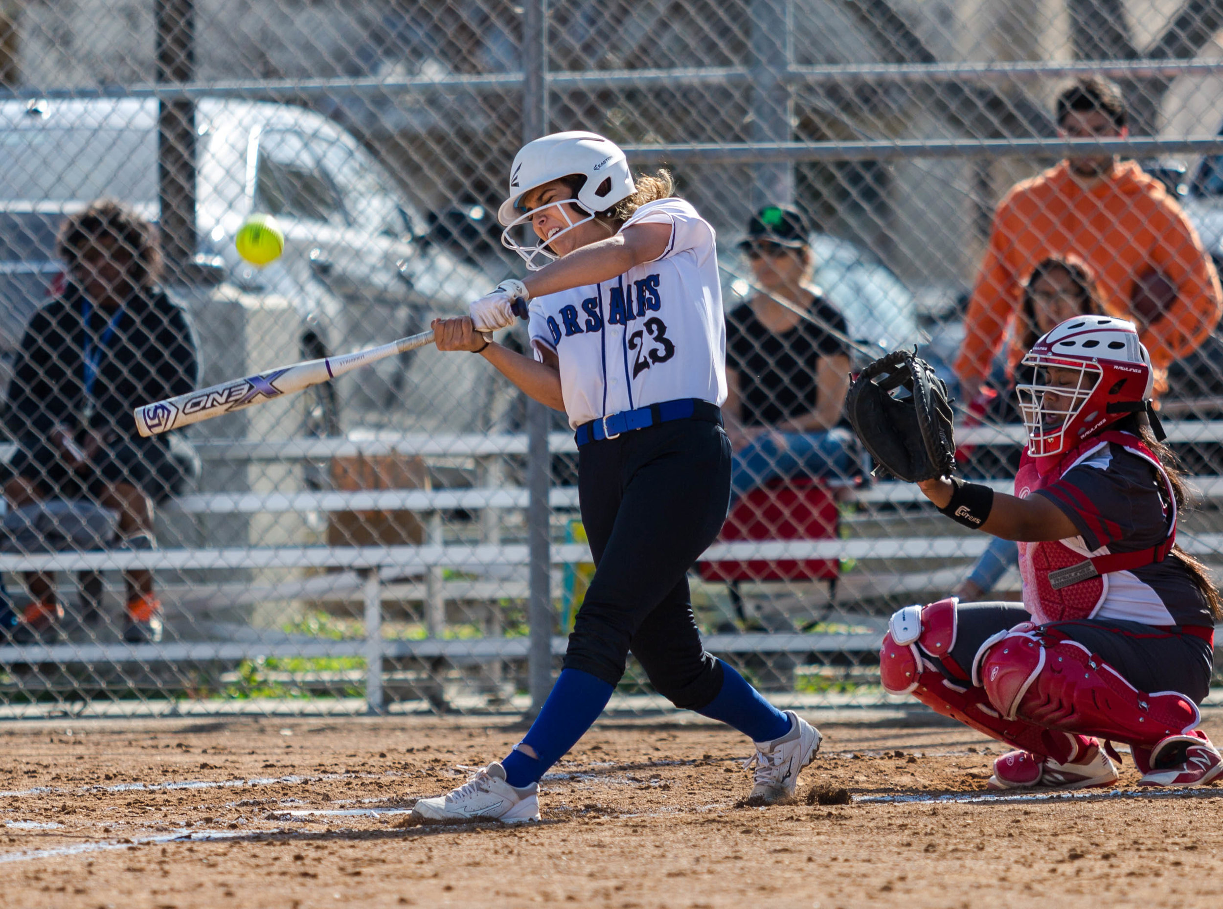 Santa Monica College Corsair batter, and former infielder, Taylor Liebesman #23 (left, white) nails a powerful curveball thrown by Bakersfield College Renegade pitcher Kylee Fahy #21 (not shown), which would get her to first base during the top of the 2nd inning at the Santa Monica College Corsair Field in Santa Monica California, on Tuesday, March 6, 2018. The Corsairs would go on to lose the game 0 – 9, despite Liebesman’s great overall performance during the game against Bakersfield College, making the Corsairs tally for the season 6 wins and 11 losses. (Corsair Photo: Matthew Martin)
