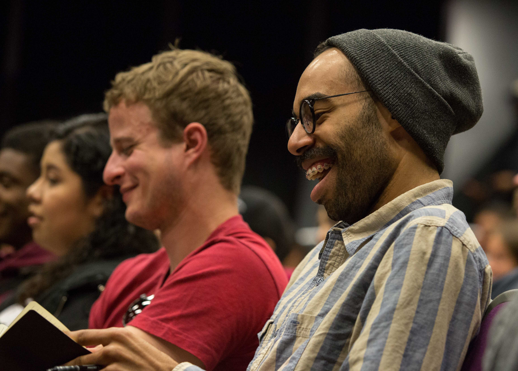 Santa Monica College student film major James Healey laughs while taking notes during the lecture Series “Inclusion in TV: Q&A with Marvel and DC Comics Television Writers” that is being presented by the Santa Monica Community College Media and Comm