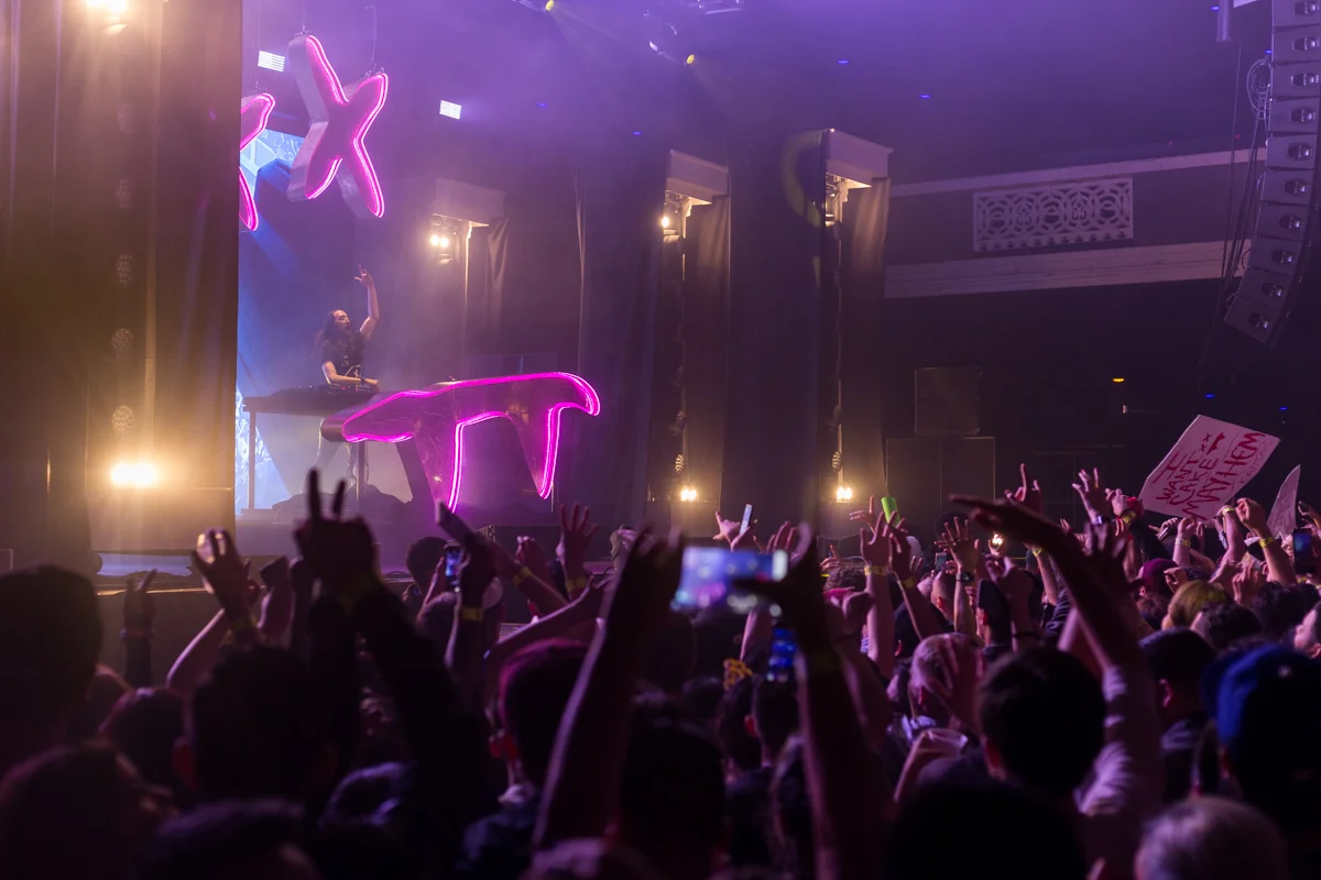 Electronic music artists and DJ Steve Aoki raises his hand to the crowd during his performance of "Boneless" at the Shrine Expo Hall and Auditorium in Downtown LA in Los Angeles, California on Friday, March 9th 2018. DJ Steve Aoki is currently on tour as part of his Kolony Tour. (Photo by: Thane Fernandes)