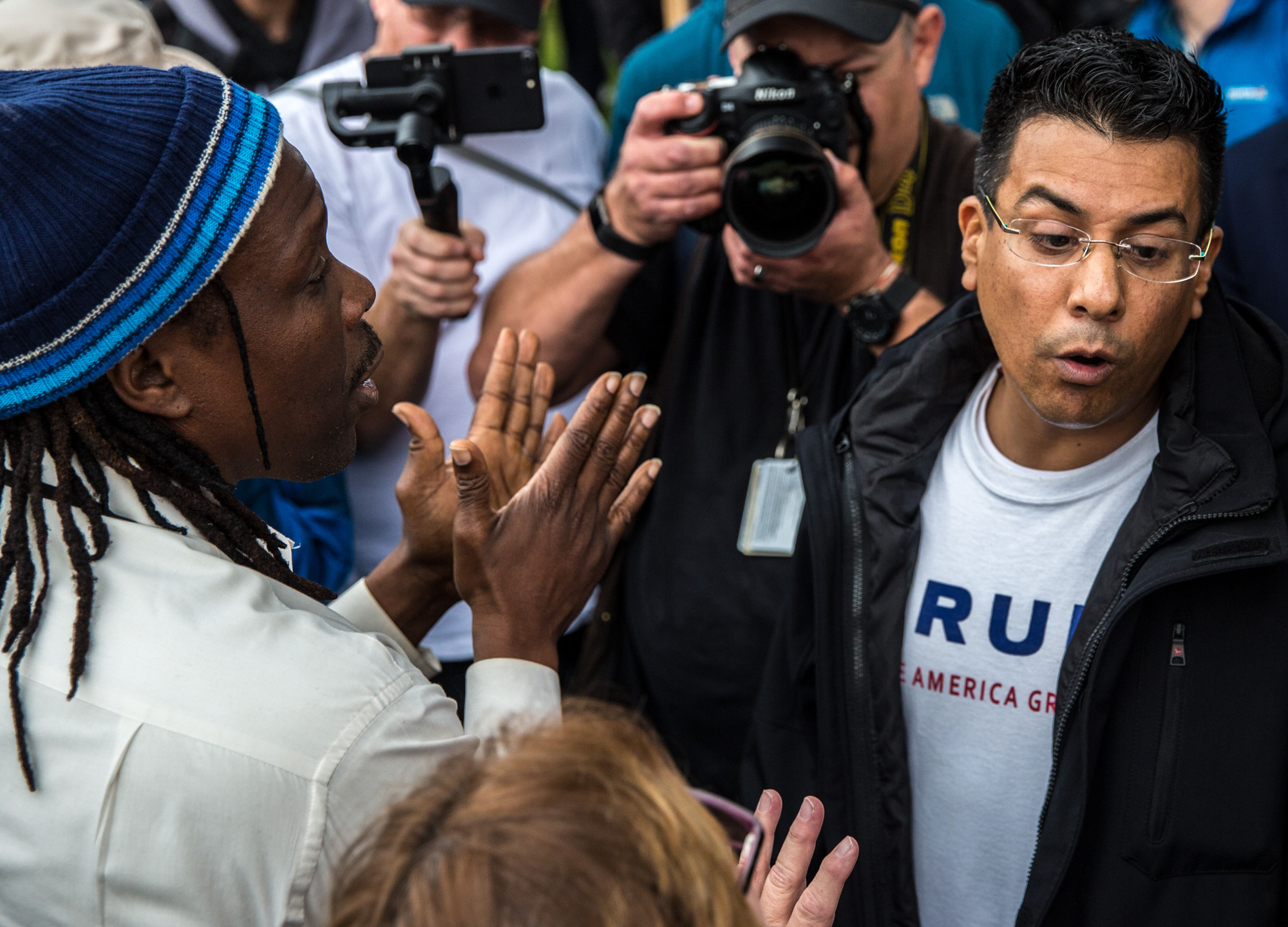 A President Donald J., Trump Supporter Danny Rodriguez (right) and anti Trump Pastor Cue Jn-Marie (left), a former Virgin Records rapper, turned evangelist discuss the civil rights movement peacefully at Beverly Gardens Park during a anti-Trump protest in Beverly Hills, California, on March 13, 2018. As President Donald Trump made his way to a fundraiser in Beverly Hills, protesters were there to greet him with their dissent during Tuesdays protest. (Photo by: Matthew Martin)