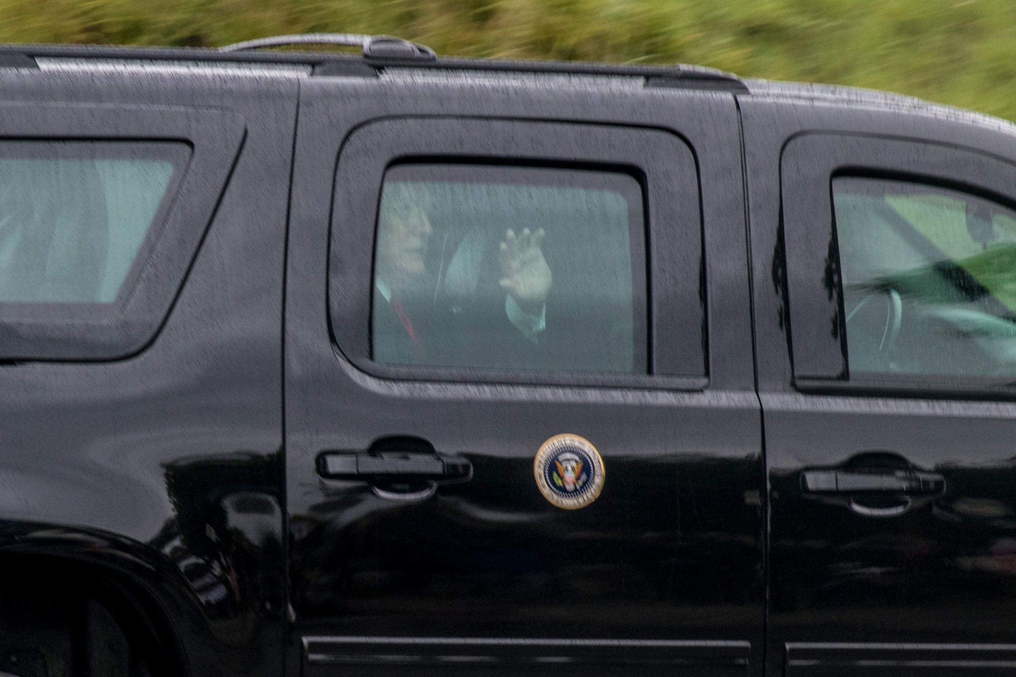 President Donald Trump waves at protestors of his presidency as he leaves the Santa Monica Airport on Tuesday, March 13, 2018 in Santa Monica, California. (Photo By: Zane Meyer-Thornton)