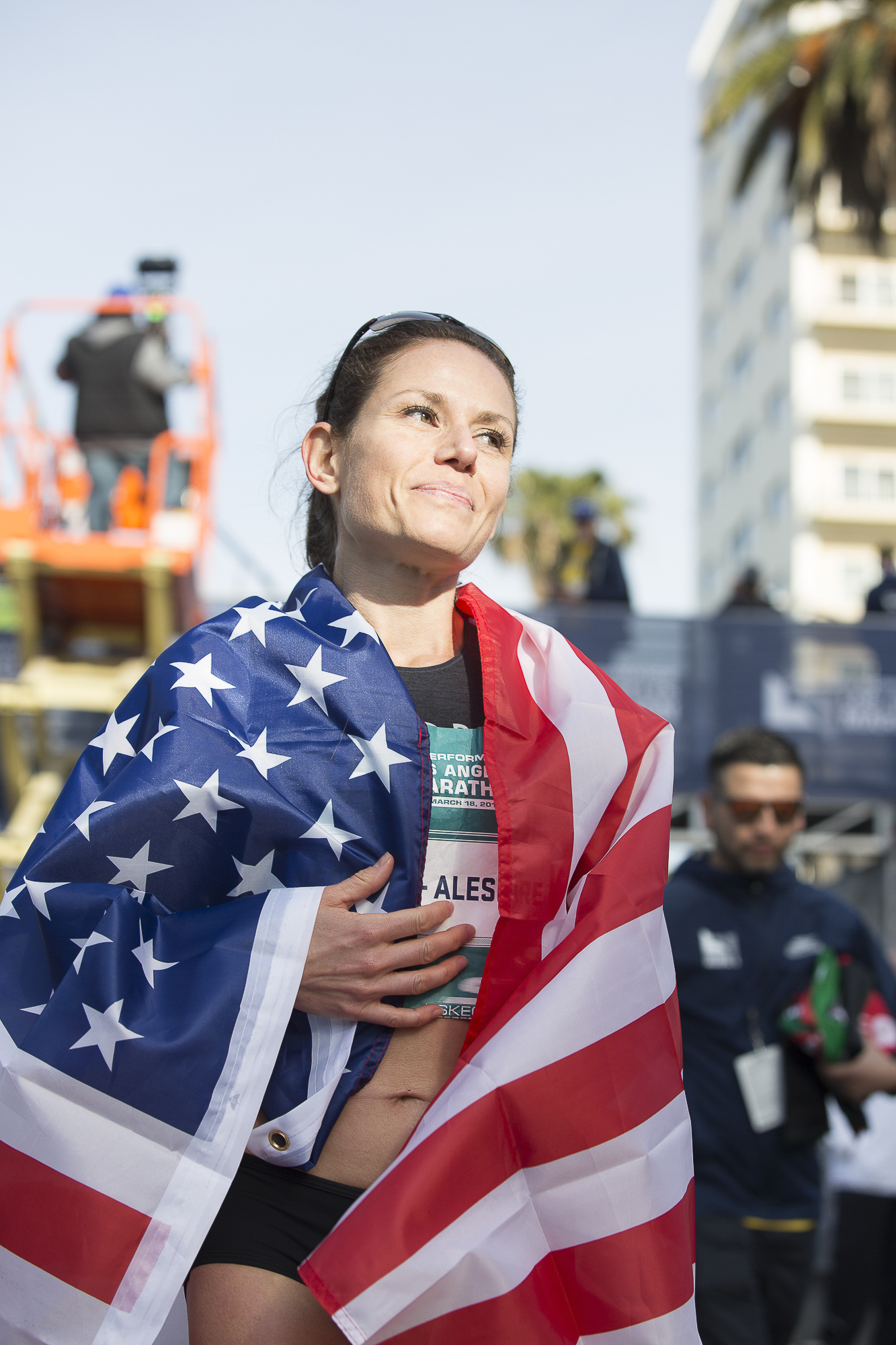  Los Angeles Marathon competitor Christina Vergara-Aleshire drapes her US flag around her after coming in fourth-place during the pro women’s LA marathon event  on March 18, 2018 in Santa Monica, California. Aleshire received the best finish by an Am