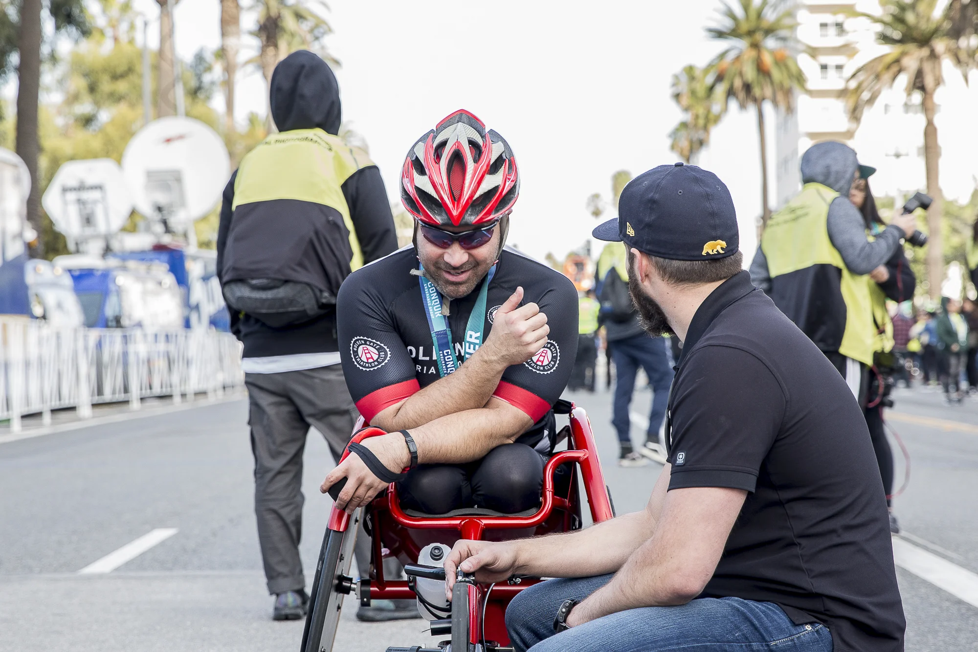 Franz Walkup (bib # 309) discusses the race with a friend of his after completing the 33rd annual Los Angeles Marathon with a final time of 1:59:54 in Santa Monica, California on Sunday, March 18 2018. (Matthew Martin/Corsair Photo)