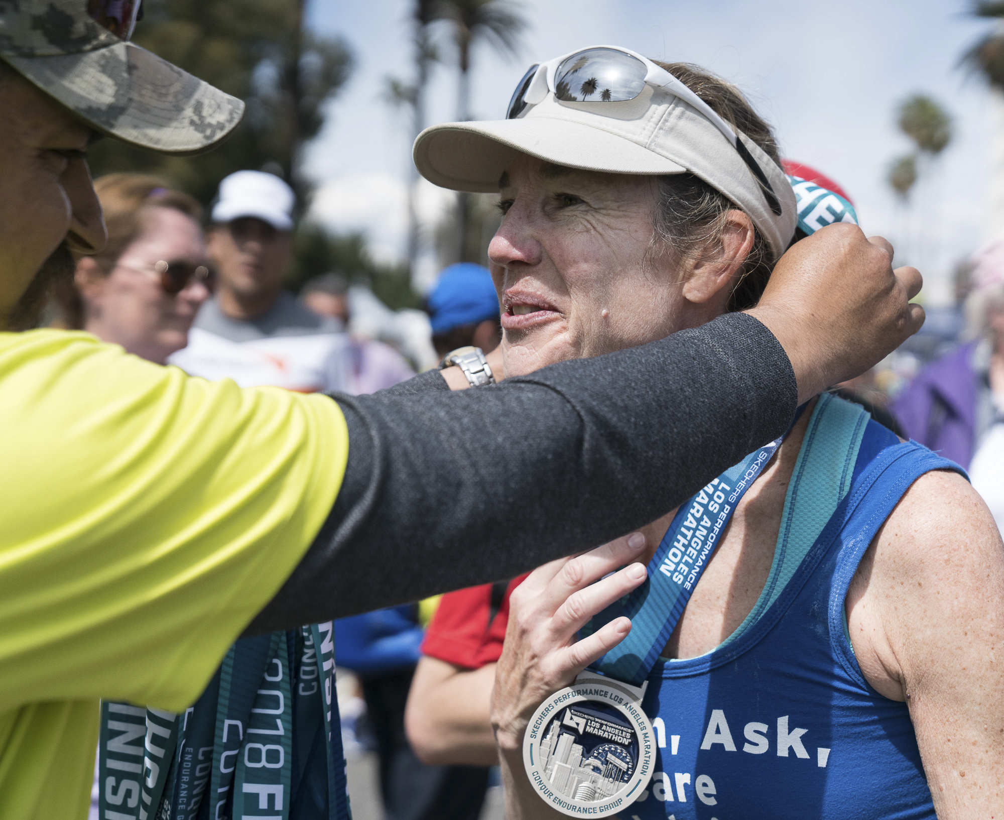  Kathy Welch, who ran the Los Angeles Marathon in memory of her son, SMC student David Sliff, receives her medal in Santa Monica, California on Sunday, March 18, 2018. This was Kathy's 13th marathon, but the first she ran in memory of her son, who di