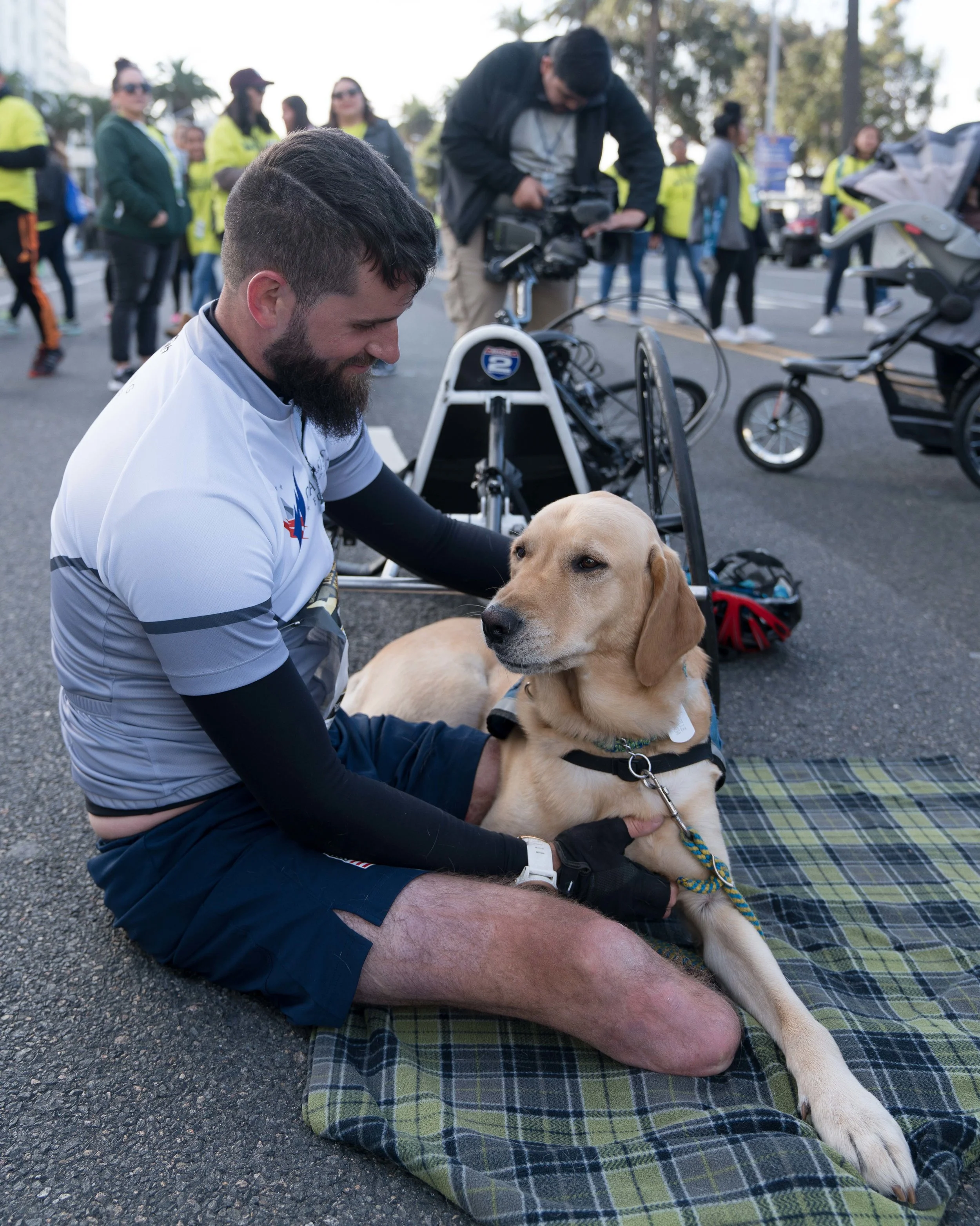 Stefan Leroy, 26, a retired United States Army Sergeant, competed as a wheelchair runner in the Los Angeles Marathon in Santa Monica, California on Sunday, Marhc 18, 2018. Leroy lost both his legs in an explosion while serving in Afghanistan in 2012. His service dog, Knoxville, helps him with daily activities. (Photo by: Helena Sung).