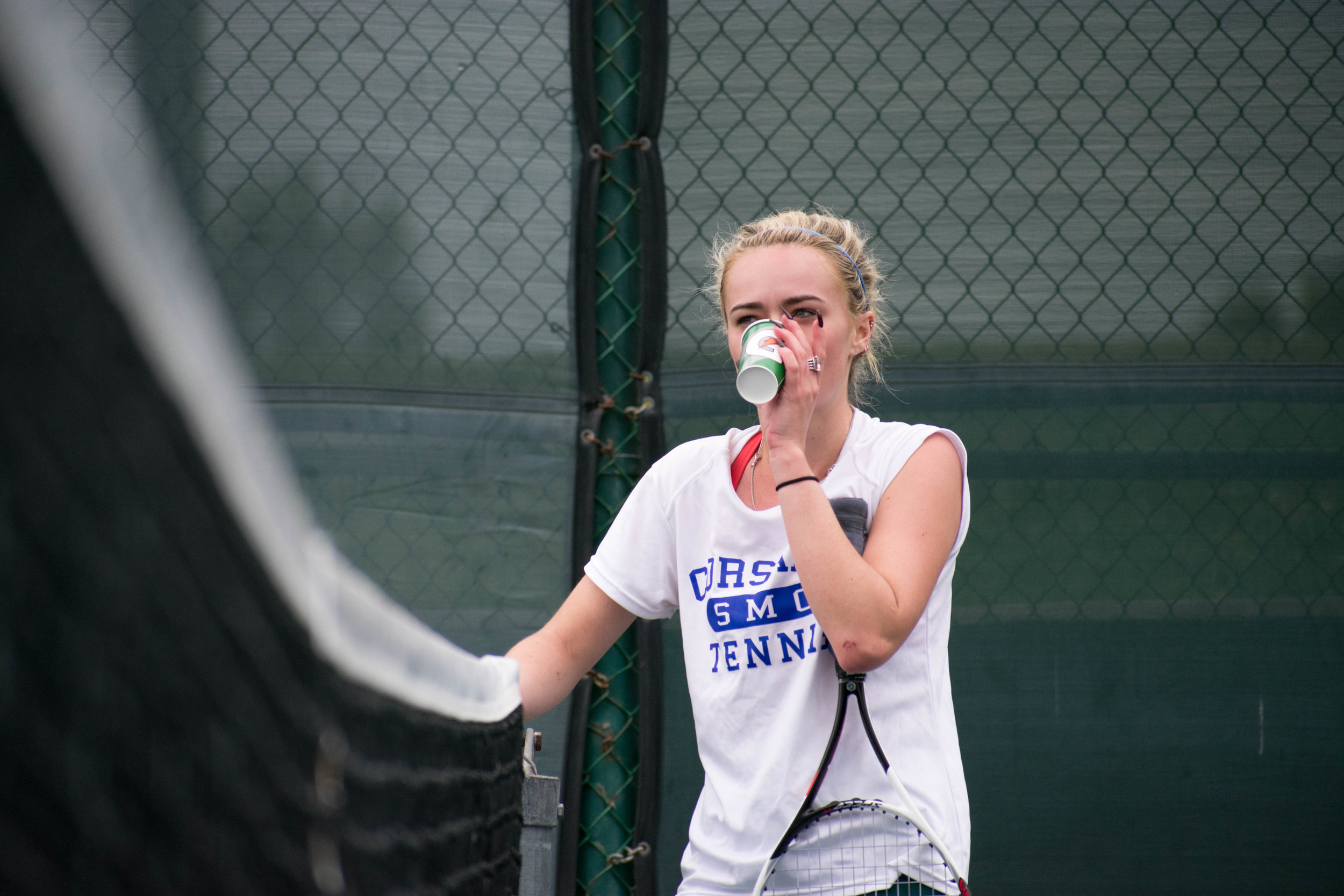  Santa Monica College Corsair sophomore Abby Mullins (#1, singles) takes a break to drink water during a singles tennis match on Tuesday, March 20 against the Glendale College Vaqueros at the Ocean View Park Tennis Courts in Santa Monica, California.