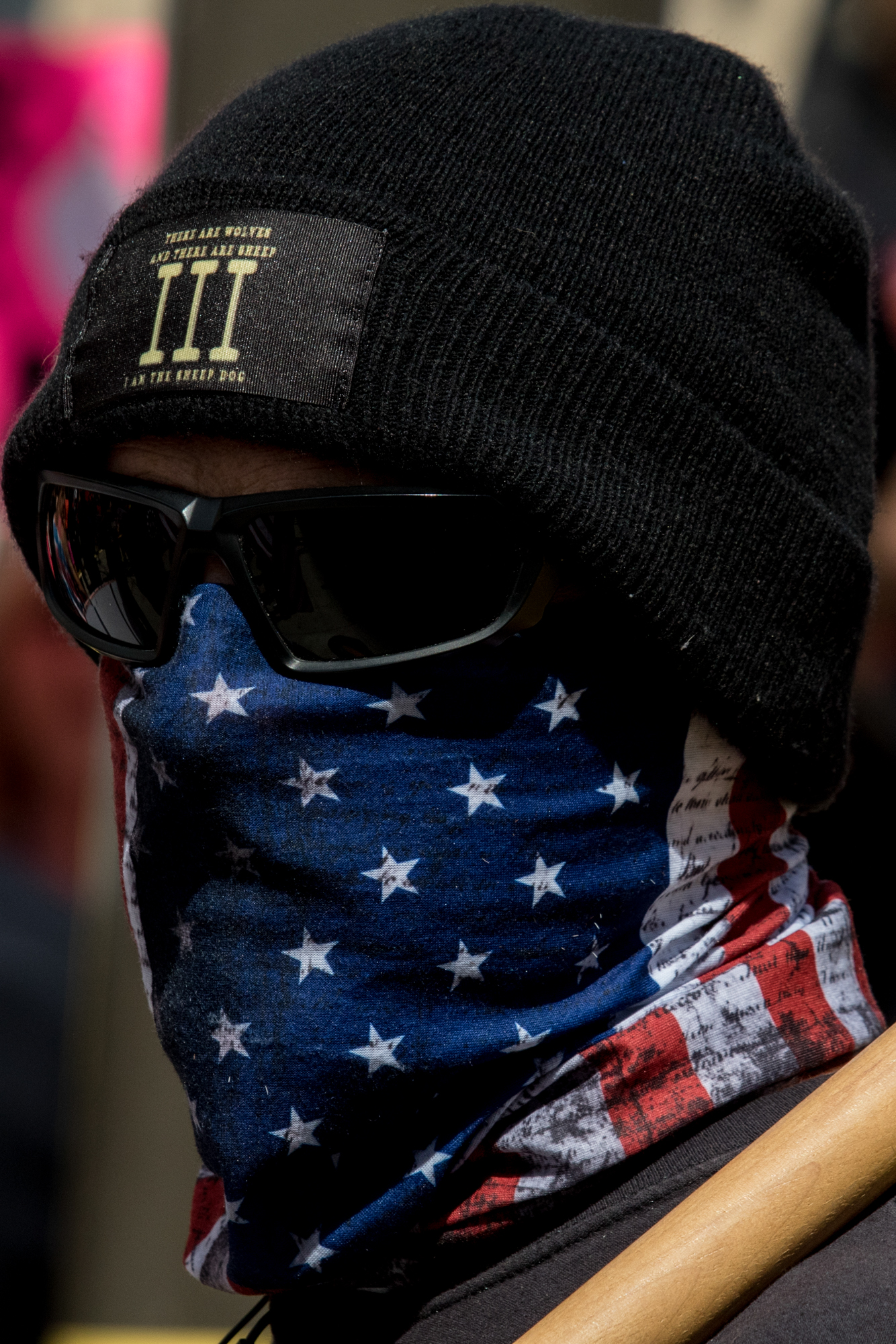 A masked Donald Trump supporter at the March For Our Lives protest on March 24, 2018 in Los Angeles, California. (Zane Meyer-Thornton/Corsair Photo)