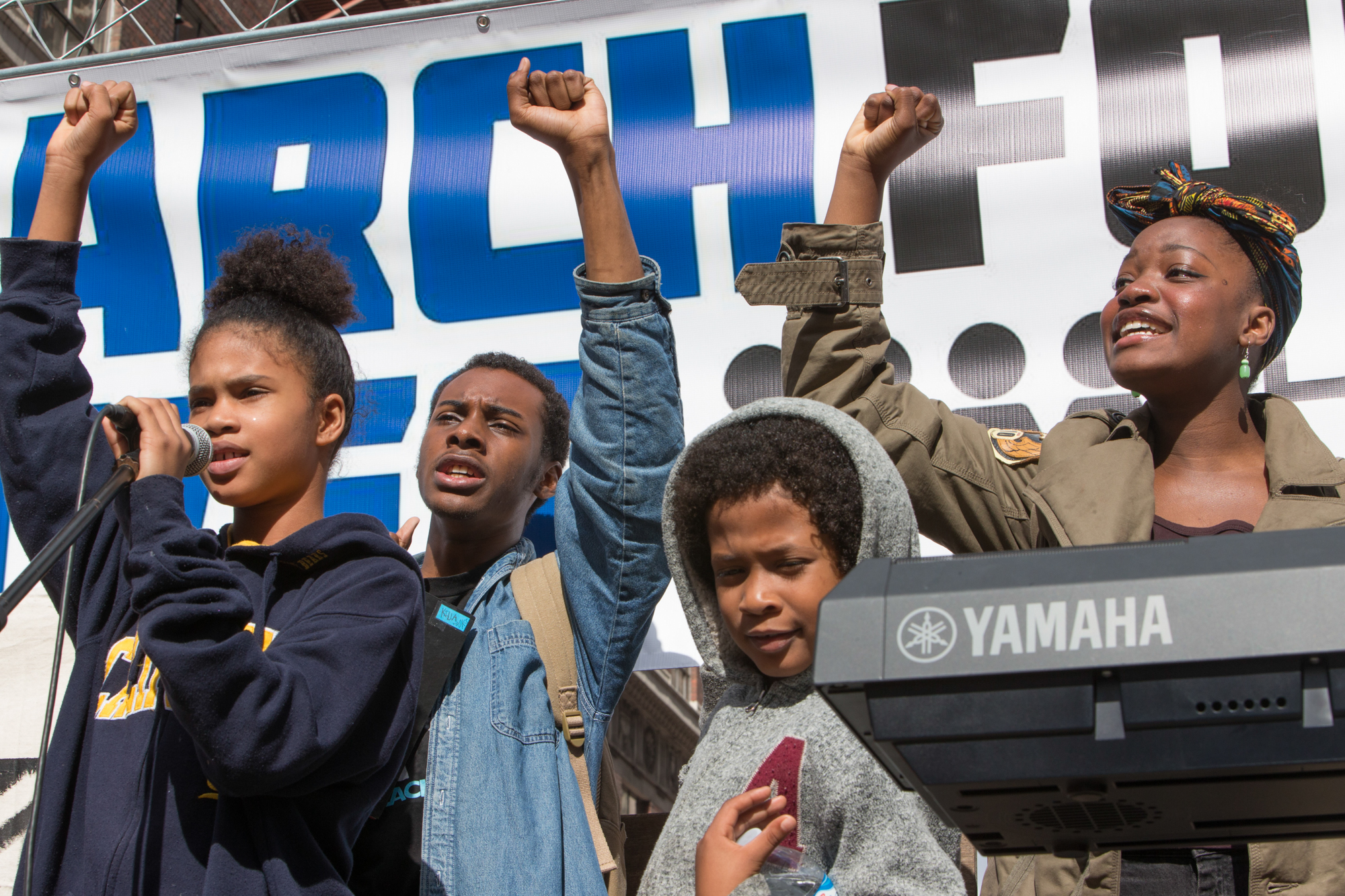 A group of young student activists, stand at the podium on 5th and Broadway in downtown Los Angeles, before marching to City Hall during the March for Our Lives rally on March 24, 2018, in Los Angeles, California. (Daniel Bowyer/Corsair Photo)