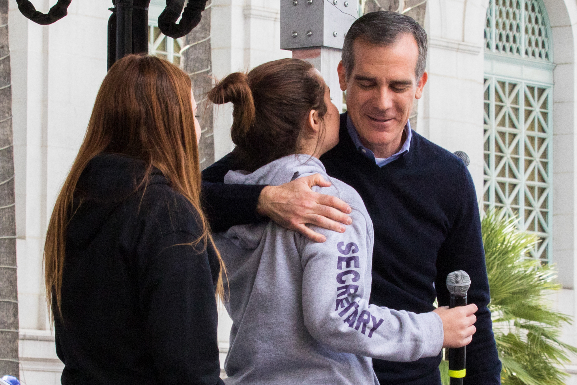 Los Angeles Mayor Eric Garcetti embraces 2 of the student speakers at the March For Our Lives protest on March 24, 2018 in Los Angeles, California. (Zane Meyer-Thornton/Corsair Photo)