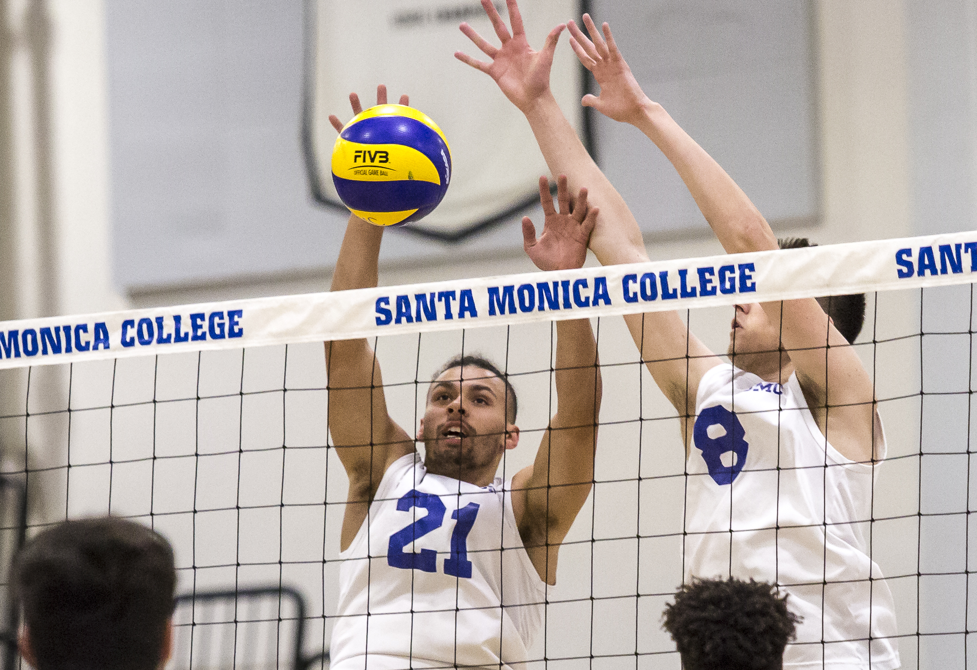  The Santa Monica College Corsair defense consisting of setter Hunter Douglas #21 (left, white) and middle-hitter Nick Kostetsky #8 (right, white) prepare for the incoming spike from the Los Angeles Trade Tech Beaver offense during the Corsairs 3-0 b