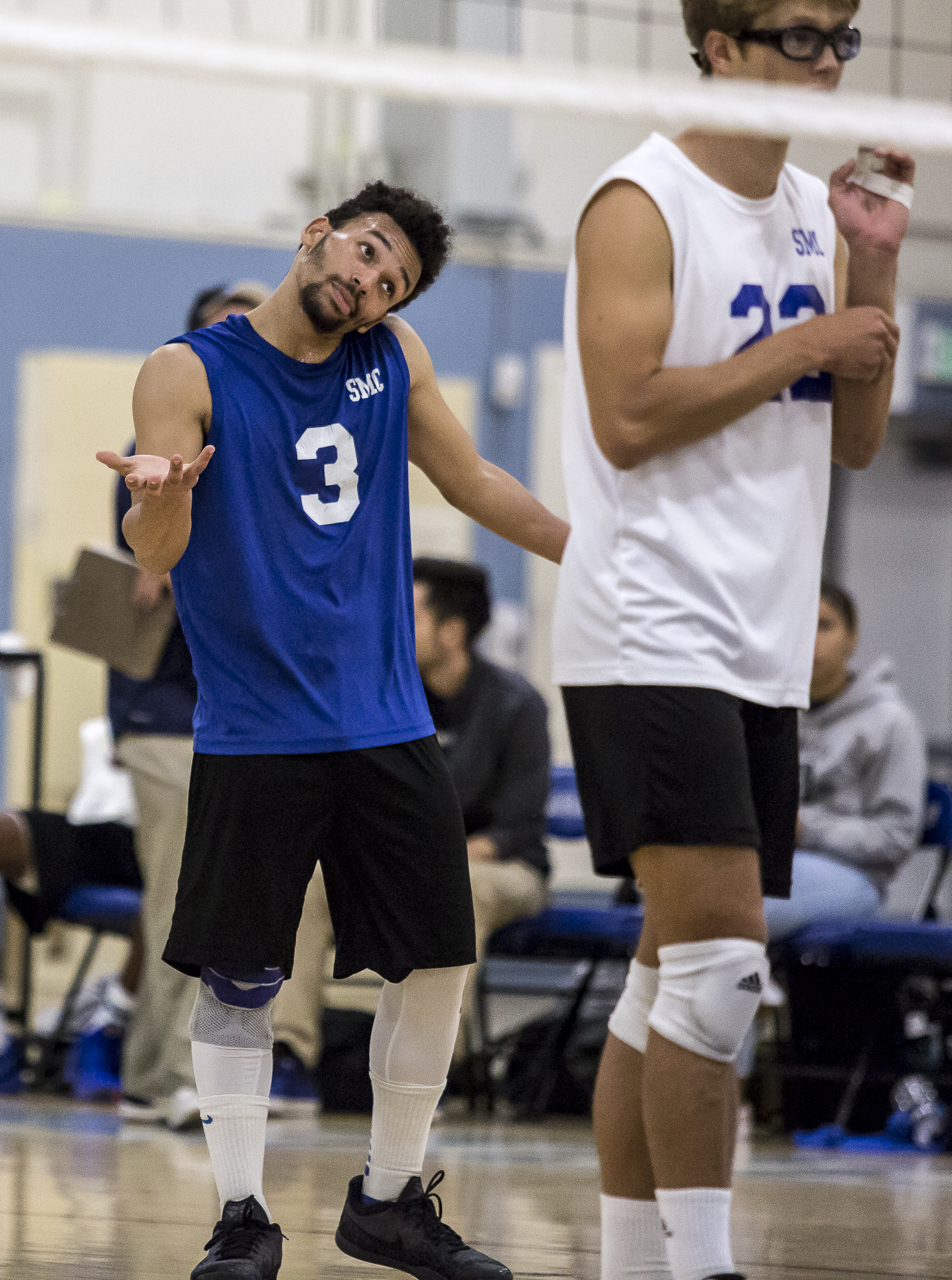  Santa Monica College Corsair Libero Elijah Chambers #3 (center/left, blue) shrugs to one of his teammates after losing a point to The Los Angeles Trade Tech College Beavers during the Corsairs 3-0 blowout victory against the Tech Beavers in the Sant