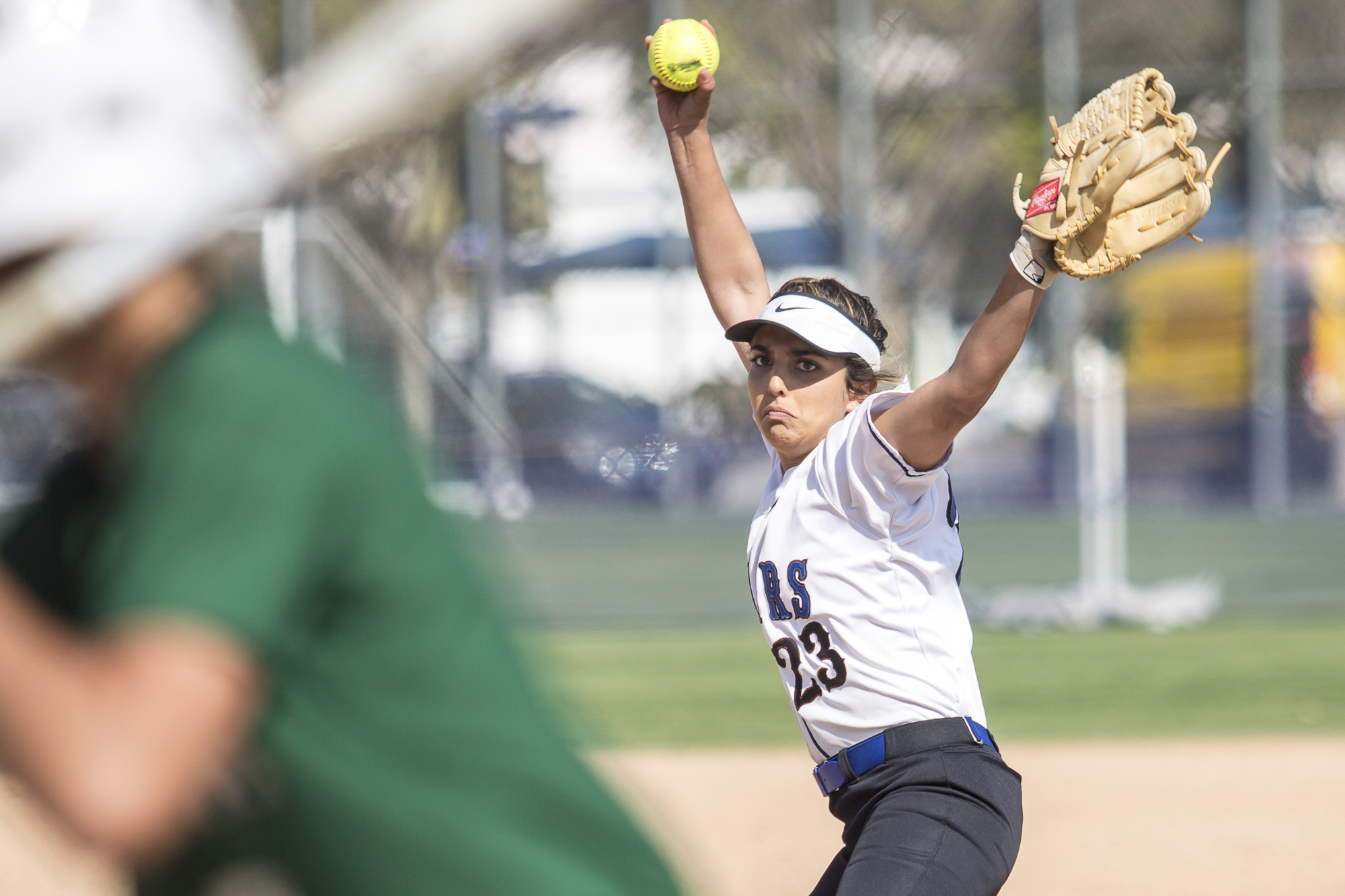 Santa Monica College freshman pitcher Taylor Liebesman winds up to pitch the ball at the Cuesta College Cougar batter at the John Adams Middle School field in Santa Monica California, on Tuesday, April 3 2018. The Santa Monica Corsairs lost 6-5 against the Cuesta College Cougars in the ten-inning softball game. (Matthew Martin/Corsair Photo)