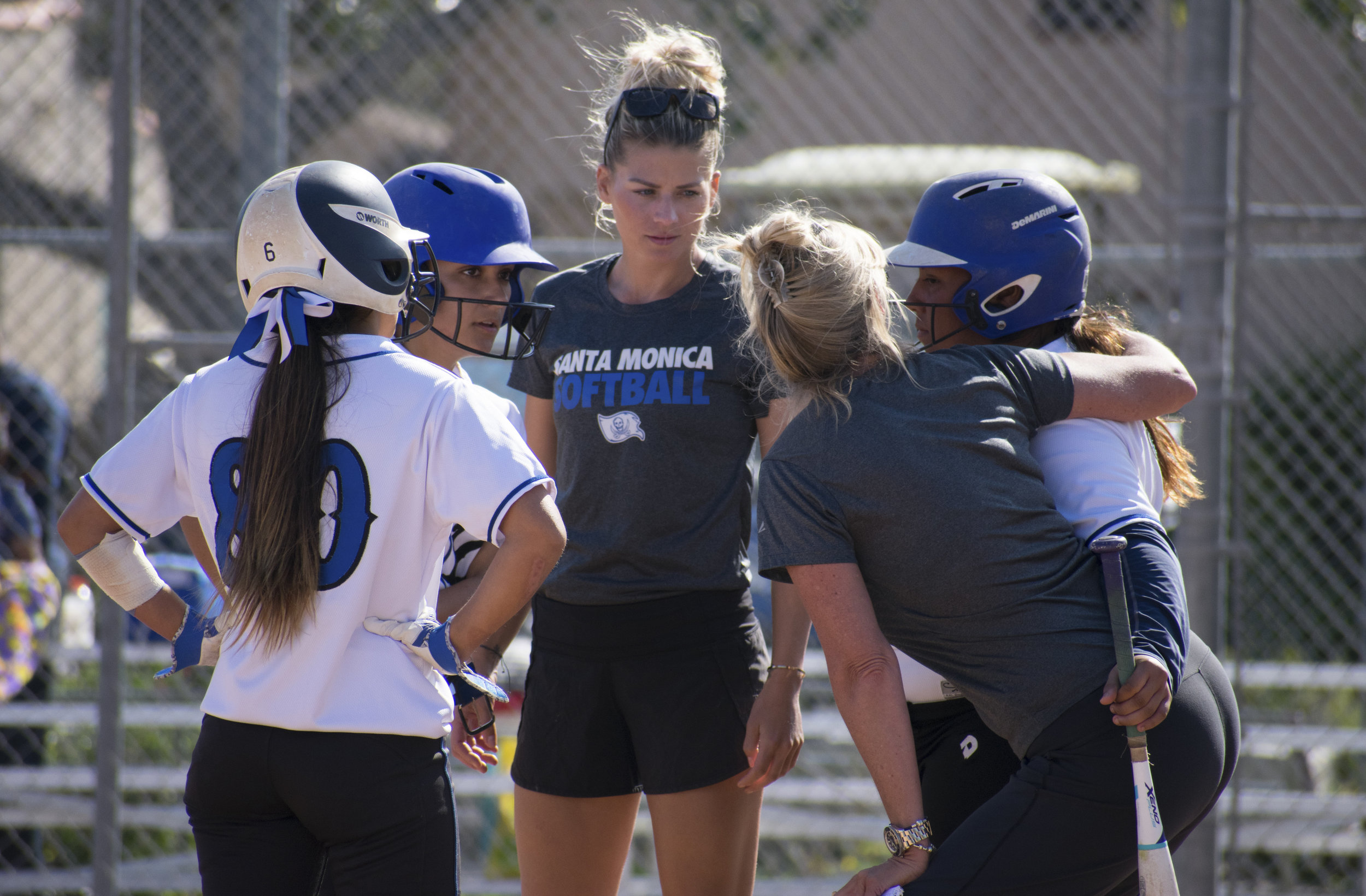 Assistant coach Sam Sheeley gives direction to the Santa Monica Corsairs during a softball game against the Cuesta College Cougars on Tuesday, April 4 at the John Adams Middle School Field in Santa Monica, California. It was a close 10-inning game, which ended in a 6-5 loss for the Corsairs. (Ethan Lauren/Corsair Photo)