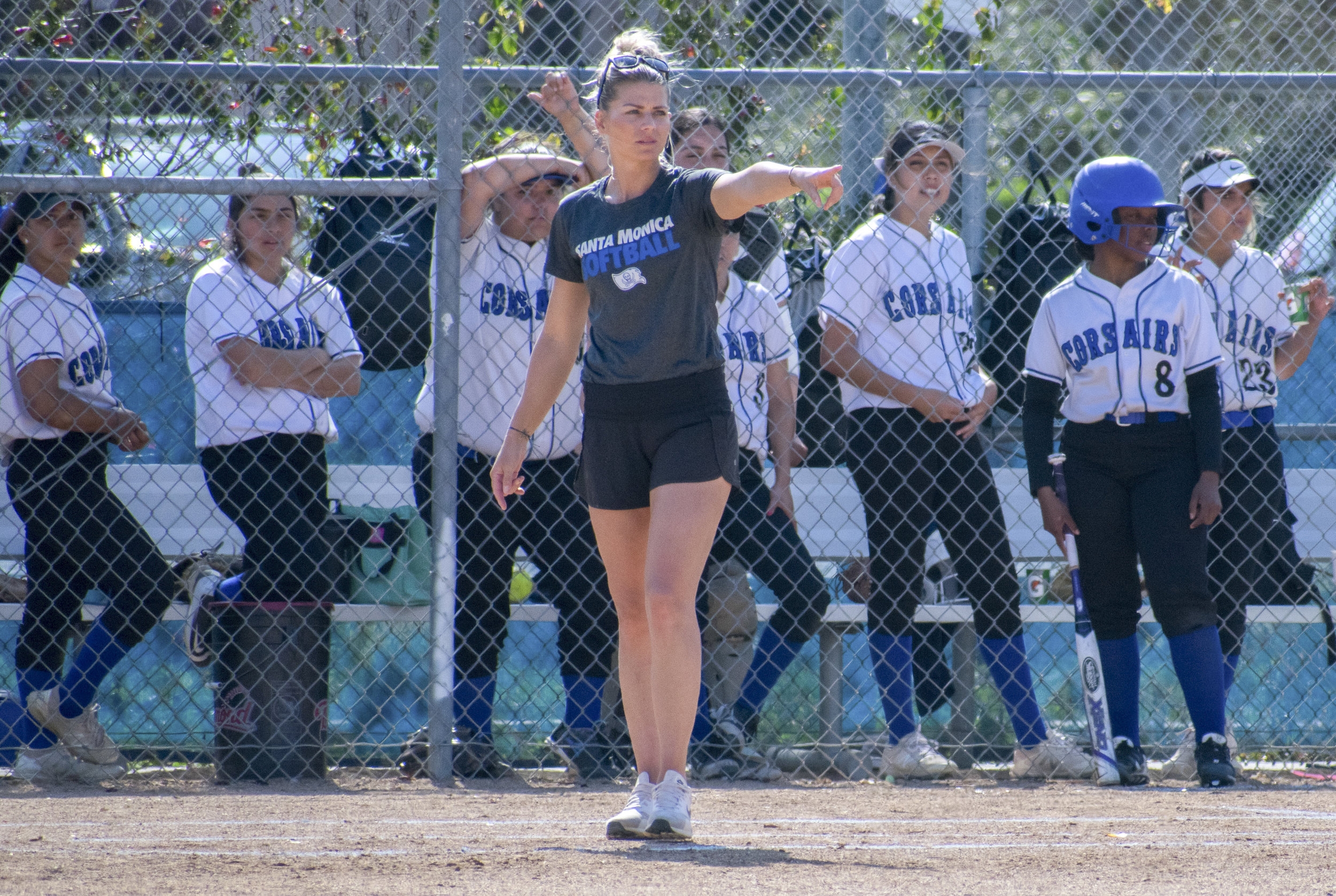  Assistant coach Sam Sheeley gives direction as the Santa Monica Corsairs look on from the dugout during a softball game against the Cuesta College Cougars on Tuesday, April 4 at the John Adams Middle School Field in Santa Monica, California. It was 