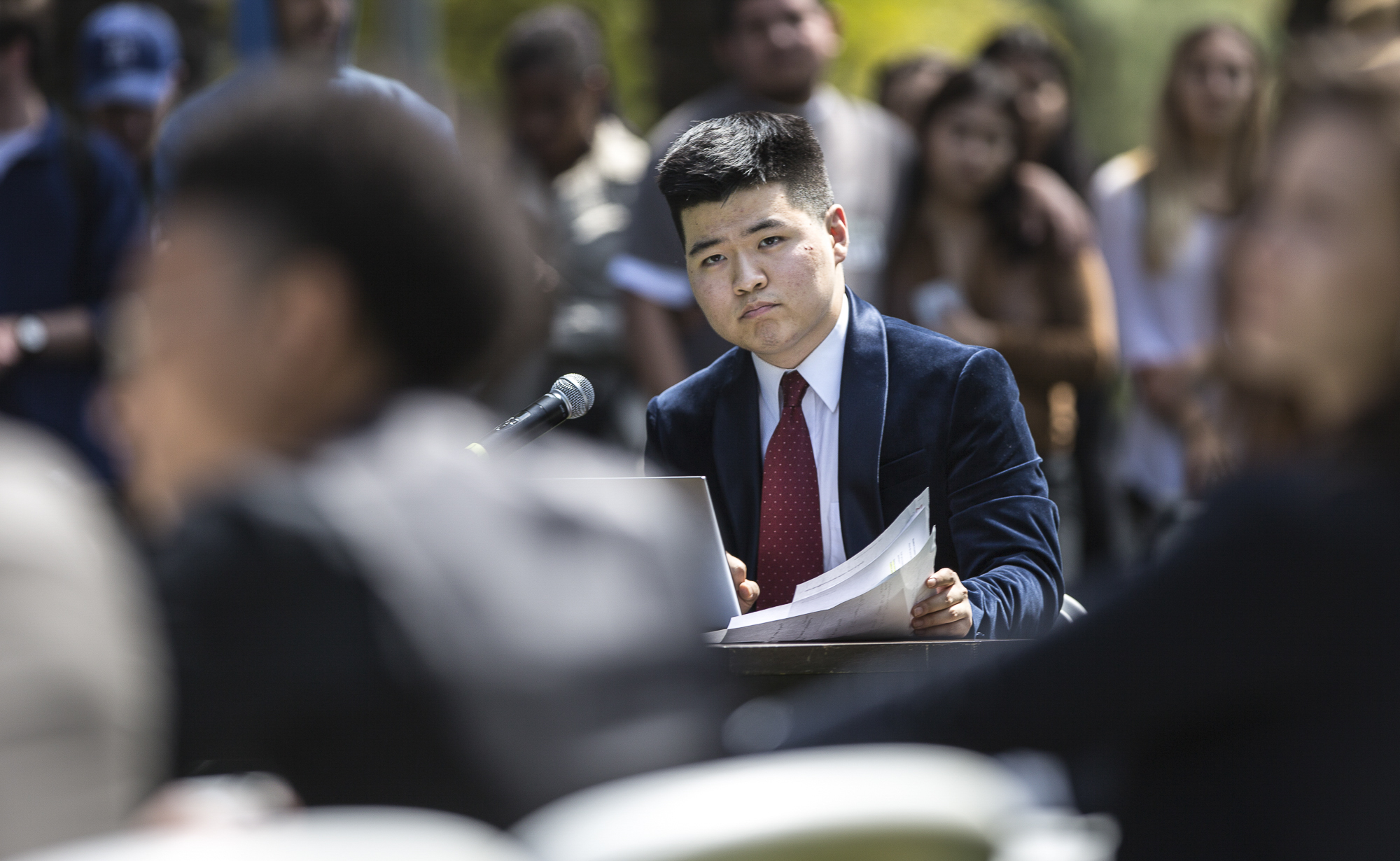  Santa Monica College Corsair Newspaper Editor in Chief Edward Lee reads questions sent in from the audience of students and faculty for Associated Student Board candidates to answer during the A.S election debate on the quad of the Santa Monica Coll