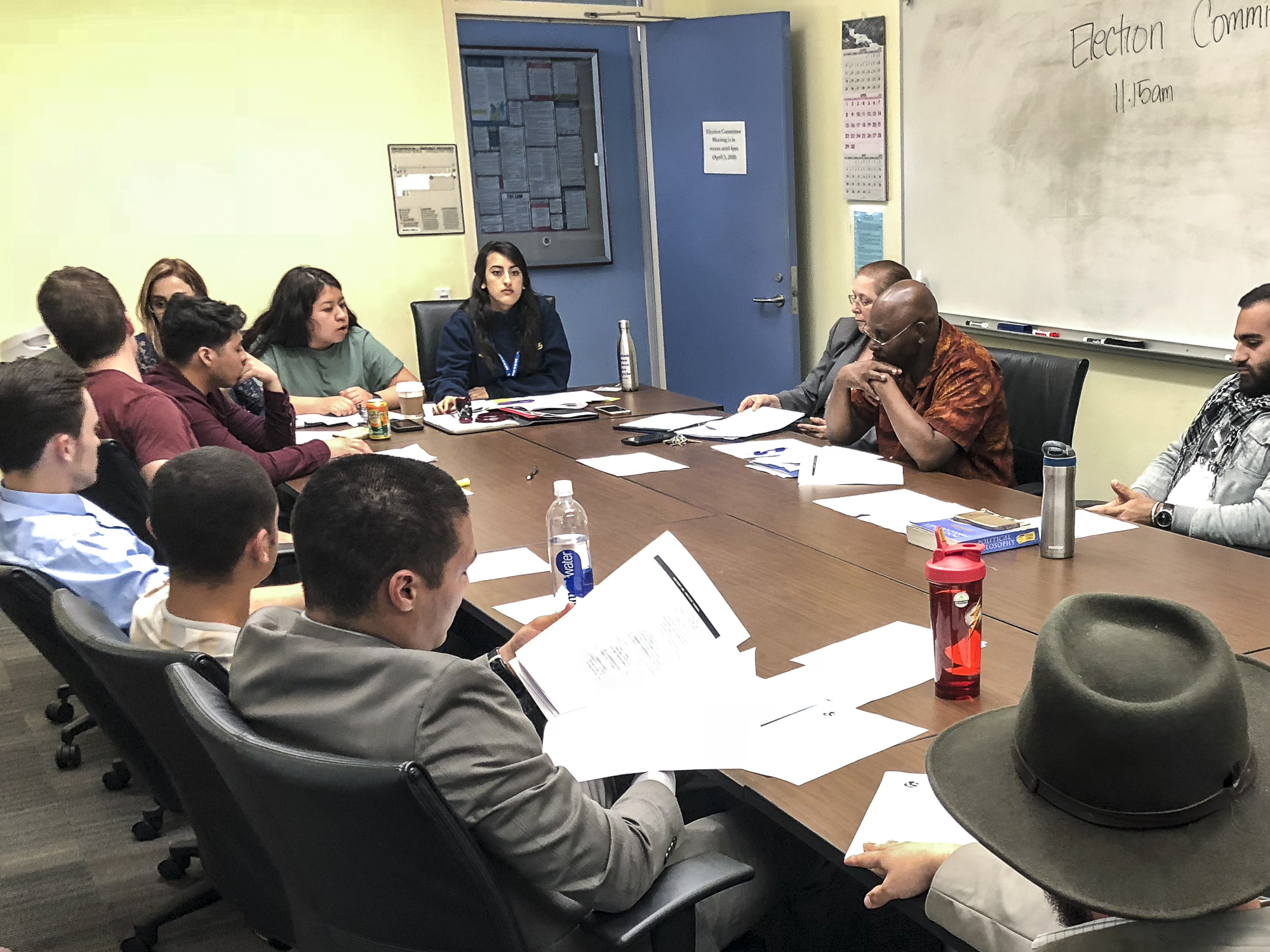 The Election Committee Members discuss a variety of filed violations amongst committee members and Associated Student candidates at the election committee meeting held in the conference room in the Cayton Center on Santa Monica College’s main campus in Santa Monica, California on Tuesday, April 3, 2018. (Pictured candidates, bottom left, Ben Kolodny, middle left, Beau Espeso, middle right, Hesham Jarmakani) (Ryanne Mena/Corsair Photo)