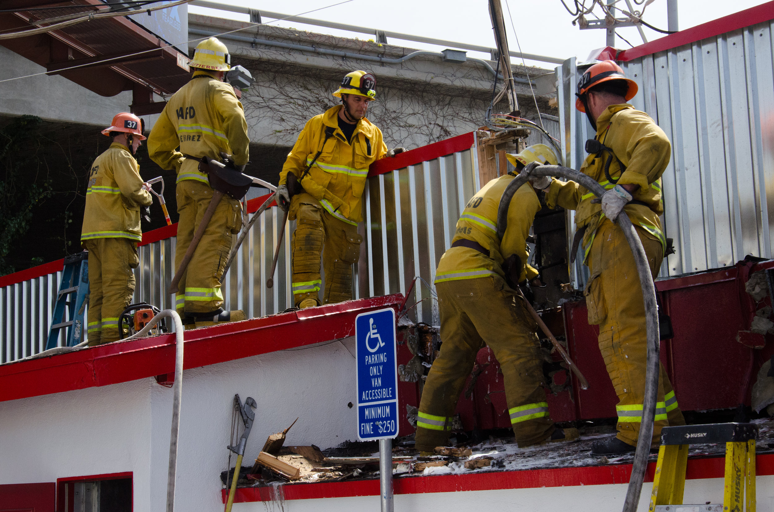  LAFD Firefighters from Station 37 extinguish the fire within the wall of Big Tomy's restaurant on Pico and Sawtelle on April 6th, 2018. (Reed Curtis/Corsair Photo) 