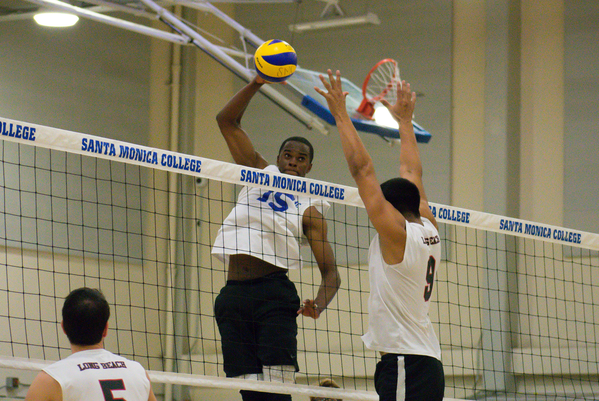 Santa Monica Corsairs sophomore and middle hitter Vecas Lewin (#15) prepares to spike the ball against the Long Beach City College Vikings during their final home game of the season on Wednesday, April 12, 2018 in the Santa Monica College gym at Santa Monica, California. The game ended in a 3-1 loss for the Corsairs, giving them a 7-7 overall rating for the season with one game left. (Ethan Lauren/Corsair Photo)