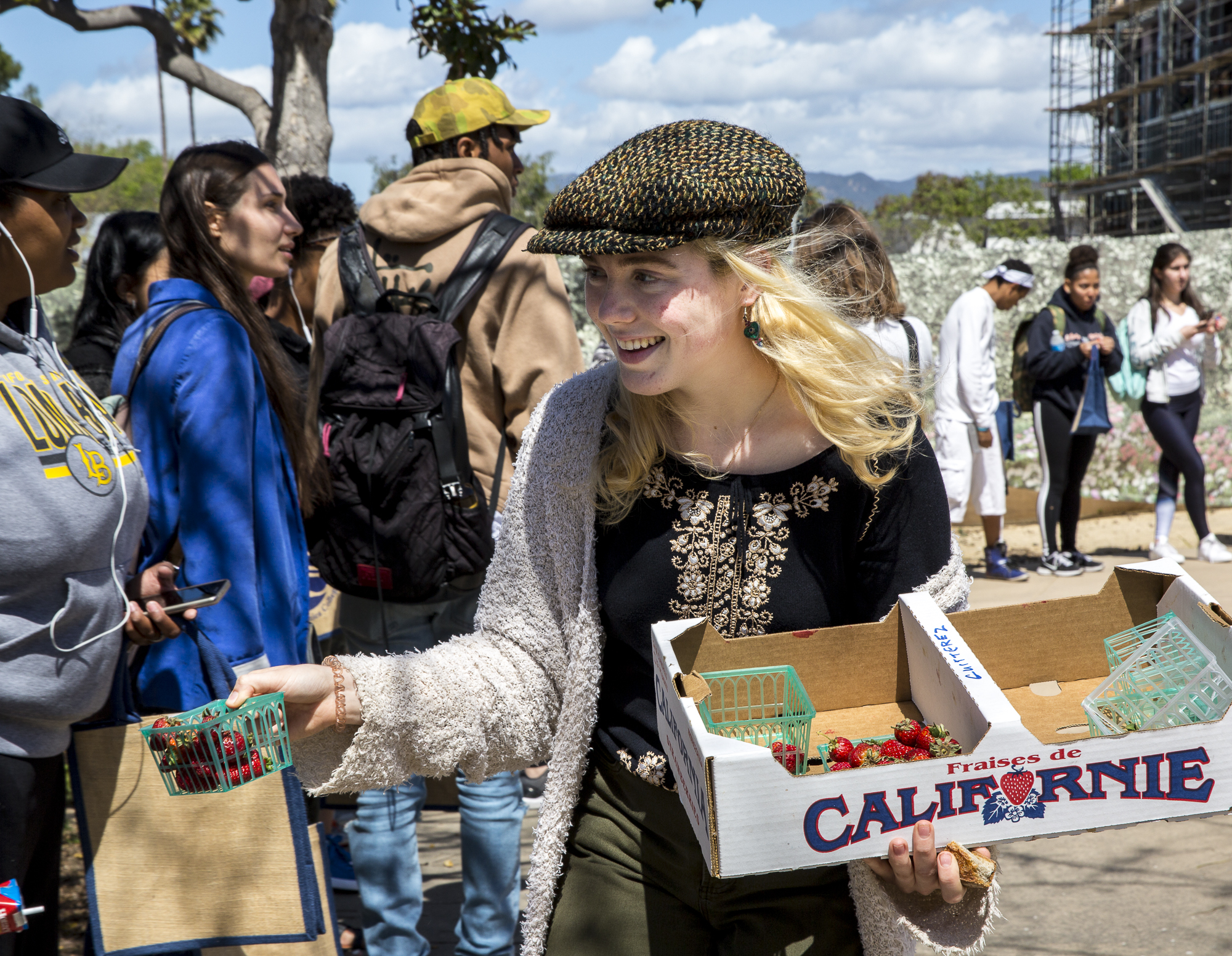 Santa Monica College (SMC) Student, ICC delegate for Club Grow and volunteer for the Earth Day event “Students Feeding Students” Brooke Harrington helps to hand out fresh strawberries to SMC students who waited in line for the Earth Day Event to begin at the Organic Learning Garden on the SMC main campus in Santa Monica California, on Monday April 16 2018. “Students Feeding Students” was the first event of a week of festivities that would take place during the SMC 2018 Earth Week, and the week would continues with environmentally conscious film screenings, environmental education workshops and a sustainability fair where non-profit organizations and green businesses would offer internships to students who are passionate about food health and the environment. (Matthew Martin: Corsair Photo)