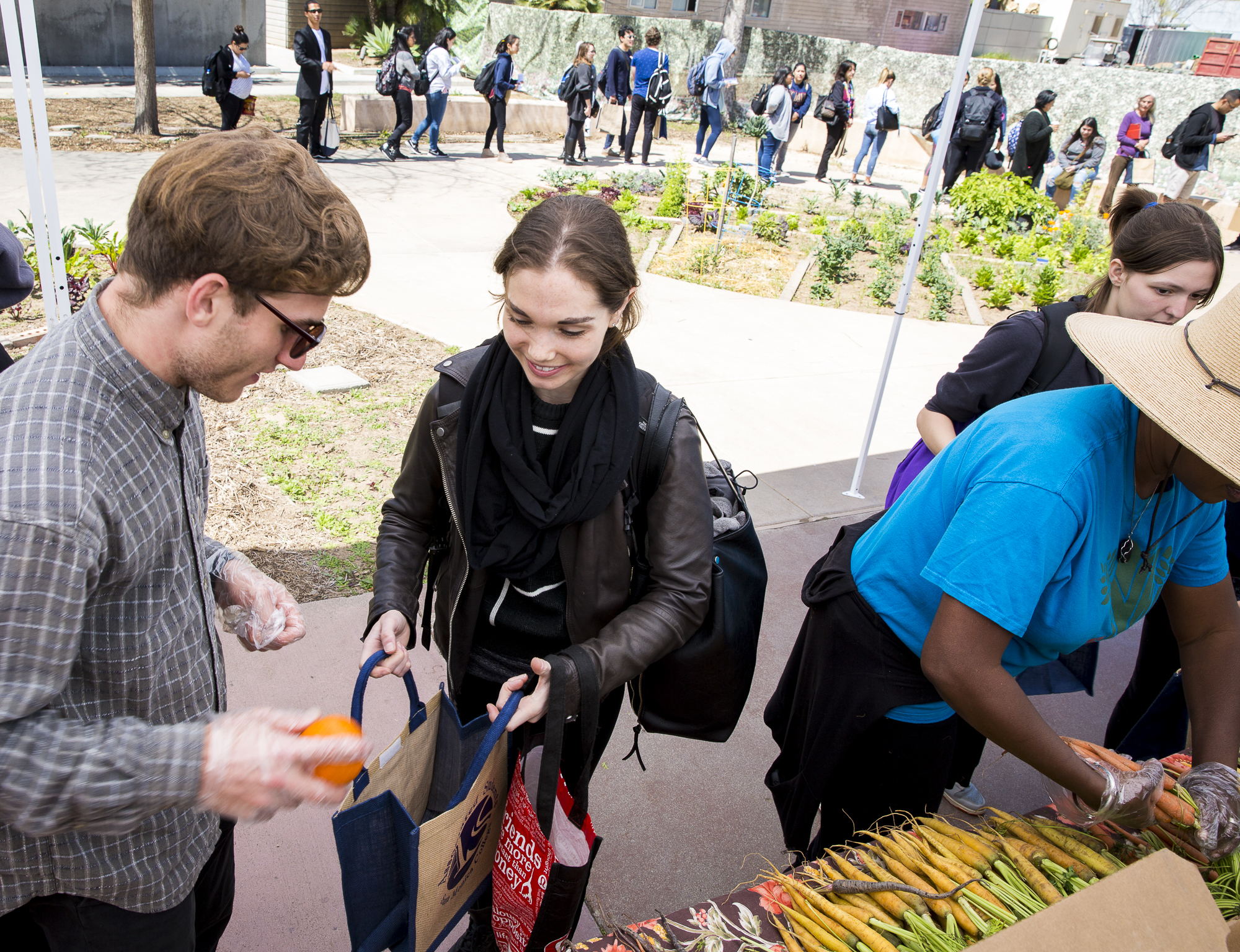  Santa Monica College (SMC) Student and Associated Student Director of Sustainability Joseph Joe Kolko (left) volunteers for the SMC Earth Day event “Students Feeding Students” by helping hand out fresh produce from the Corsair Farmers Market to SMC 