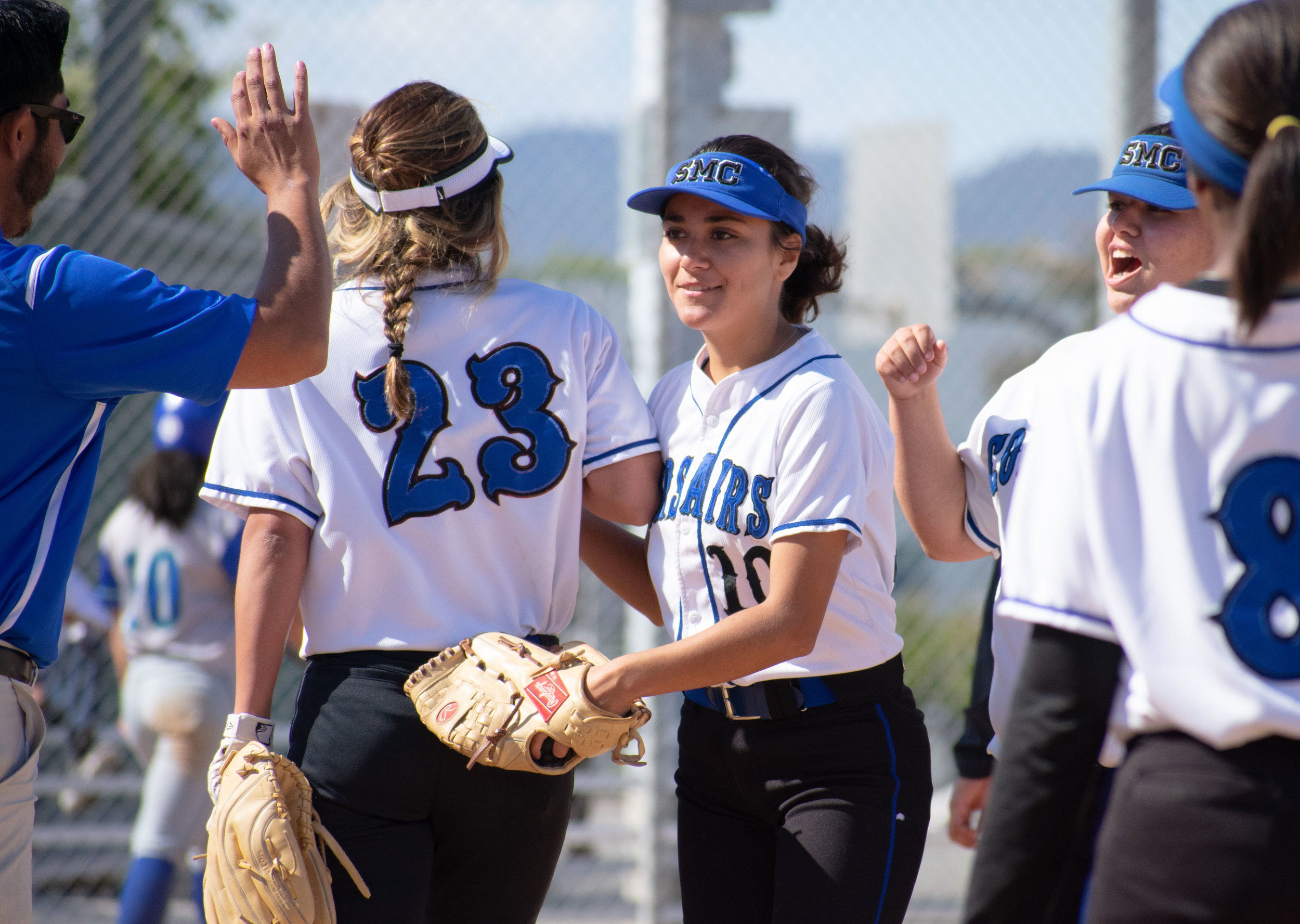 Santa Monica College Corsair Briana Osuna (#10), center, congratulates with the rest of the team after a 3-2 win against the Oxnard Condors in a softball game on Thursday, April 19, 2018 at the John Adams Middle School Field in Santa Monica, California. The game broke a seven-game losing streak on their penultimate game of the season. (Ethan Lauren/Corsair Photo)