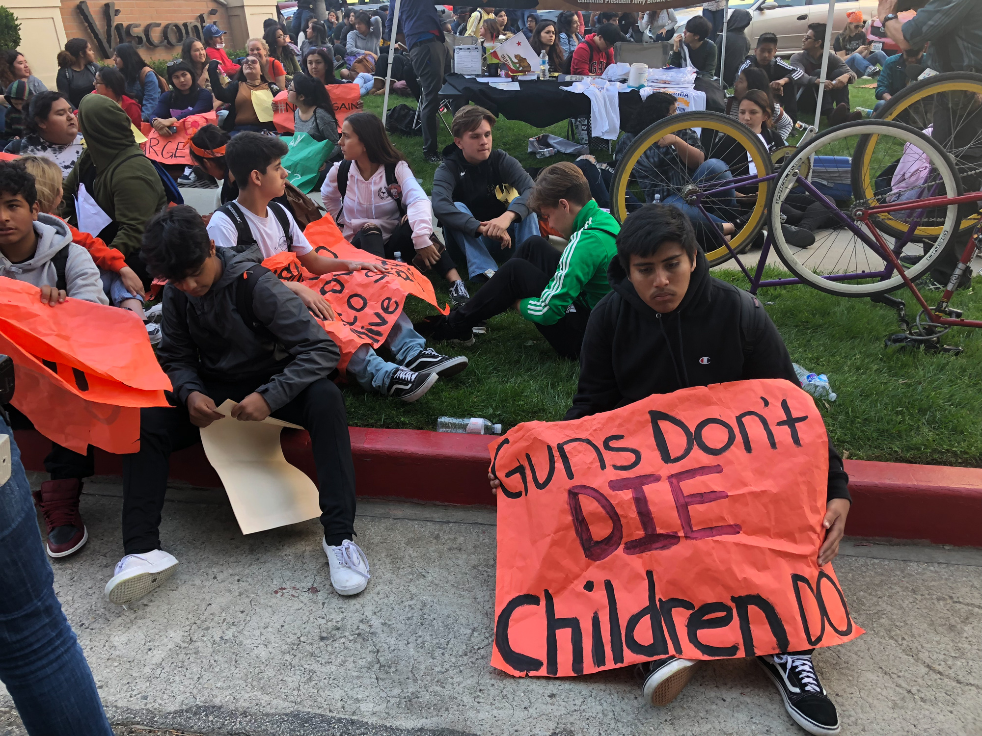  Javier Villega Angel Linda Marquez, freshman at Linda Marquez high school, sits on the curb surrounded by his fellow students while folding a sign that reads, ‘Guns Don’t DIE Children Do’ in front of the Los Angeles Unified School District headquart