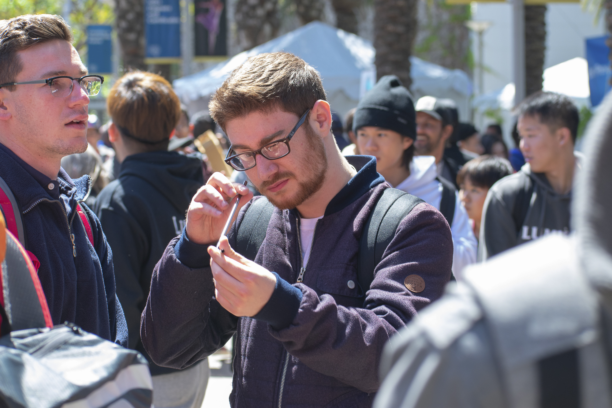 On the quad at Santa Monica College, Rafael Alvarez inspects a metal straw given to him by Plastic Free SMC during Club Row on Thursday, April 26, 2018 in Santa Monica, California. With over 60 clubs in attendance, the day is meant to encourage clubs to showcase what they’ve been doing over the semester for students. (Ethan Lauren/Corsair Photo)