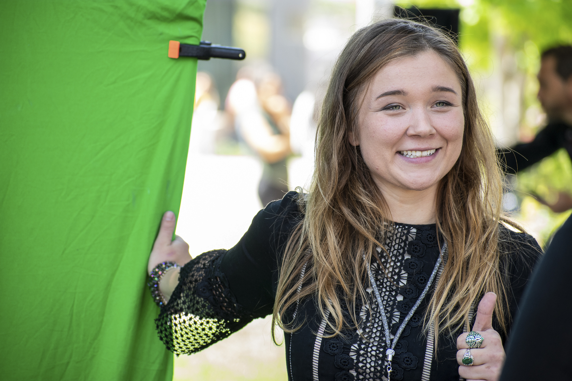 On the quad at Santa Monica College, Katharine Nilsen stands next to a green screen for Urban Mediamakers West during Club Row on Thursday, April 26, 2018 in Santa Monica, California. With over 60 clubs in attendance, the day is meant to encourage clubs to showcase what they’ve been doing over the semester for students. (Ethan Lauren/Corsair Photo)