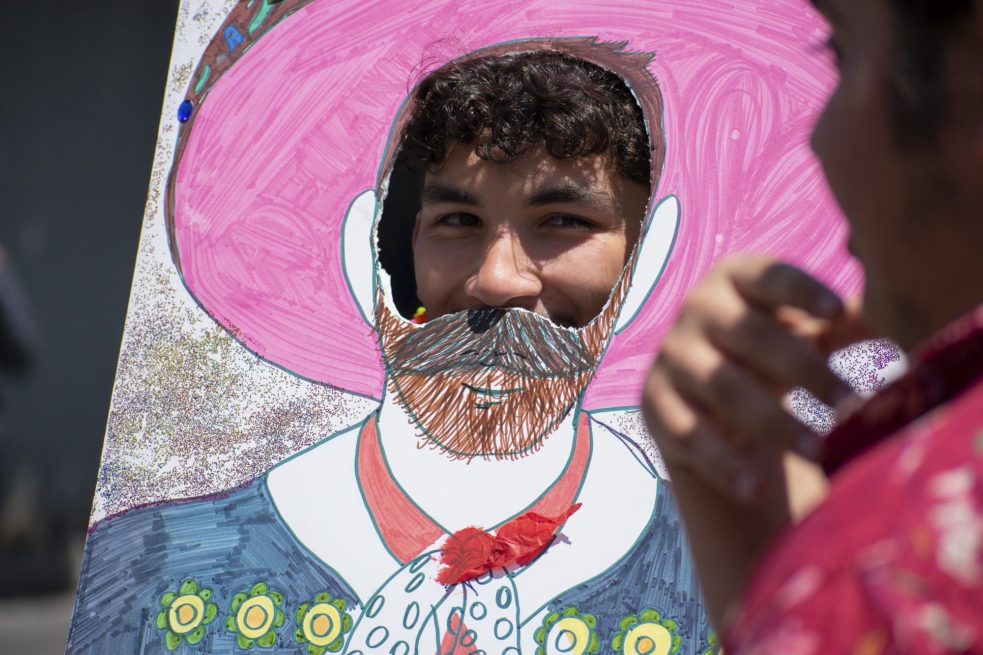 Christian Escovar poses for a friend in front of the Adelante Club’s booth on the quad at Santa Monica College during Club Row on Thursday, April 26, 2018 in Santa Monica, California. With over 60 clubs in attendance, the day is meant to encourage clubs to showcase what they’ve been doing over the semester for students. (Ethan Lauren/Corsair Photo)