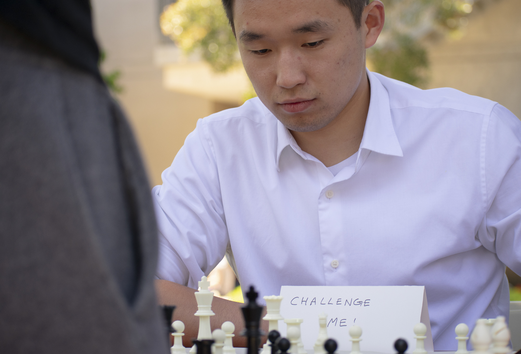 Enkhtuvshin Doyodkhuu, the president of the Chess Club, plays a game with a passerby on the quad at Santa Monica College during Club Row on Thursday, April 26, 2018 in Santa Monica, California. With over 60 clubs in attendance, the day is meant to encourage clubs to showcase what they’ve been doing over the semester for students. (Ethan Lauren/Corsair Photo)