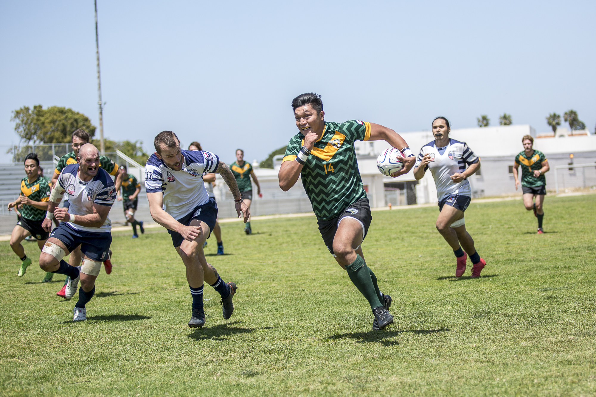  Santa Monica Dolphin rugby forward Joey Krassenstein (#14, green)  charges down the field during the 1st half of the game, which was held at Westchester High School in Westchester California on Saturday April 28 2018. The Santa Monica Dolphins would