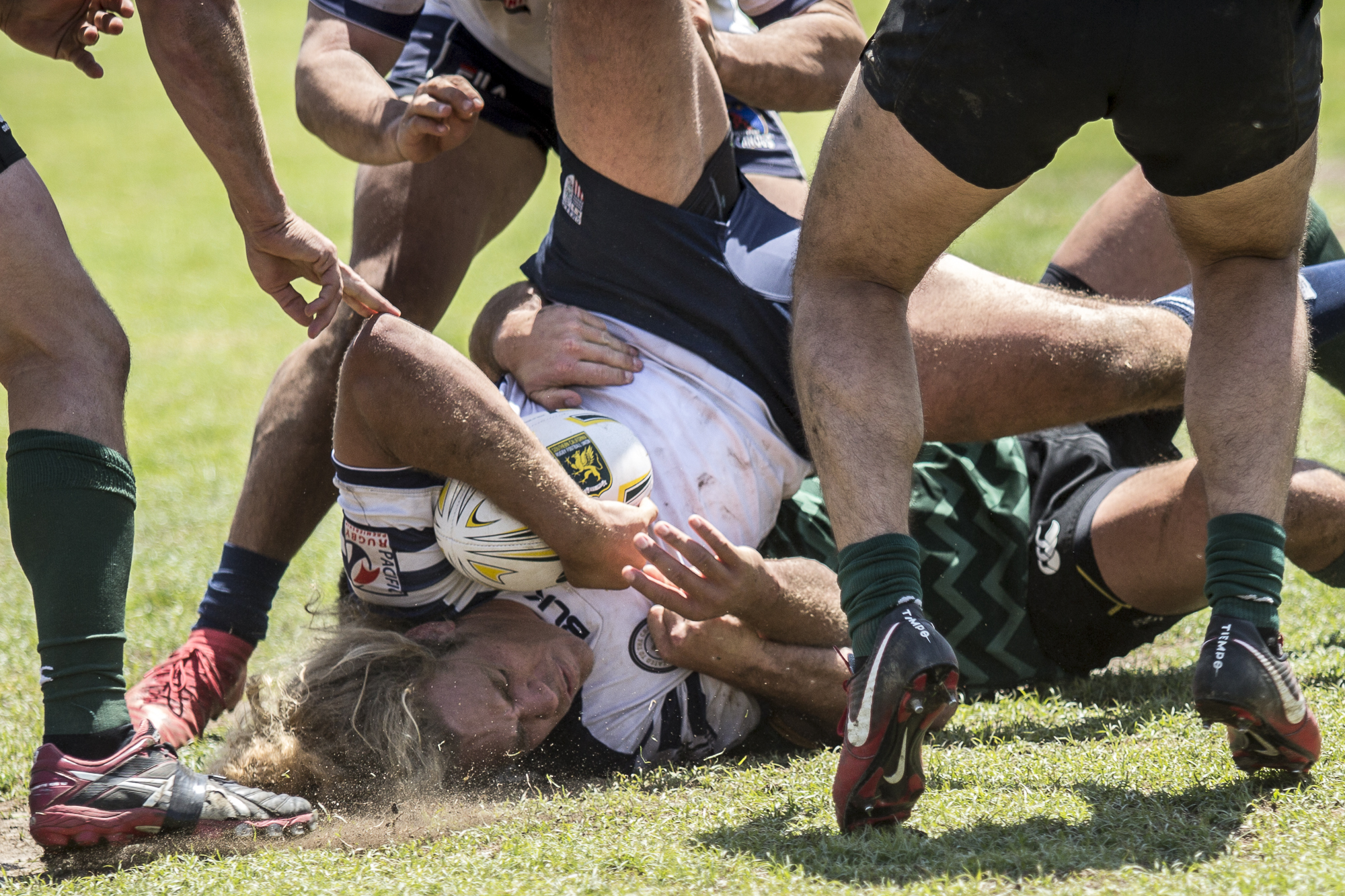 Old Mission Beach Athletic Club (OMBAC) rugby forward Shane Moise is tackled hard near the try line by the Santa Monica Dolphin defense Santa Monica Dolphins at Westchester High School field in Westchester California on Saturday April 28 2018. The Santa Monica Dolphins would go on to lose the game 7-26 during Saturday’s game. (Matthew Martin/Corsair Photo)