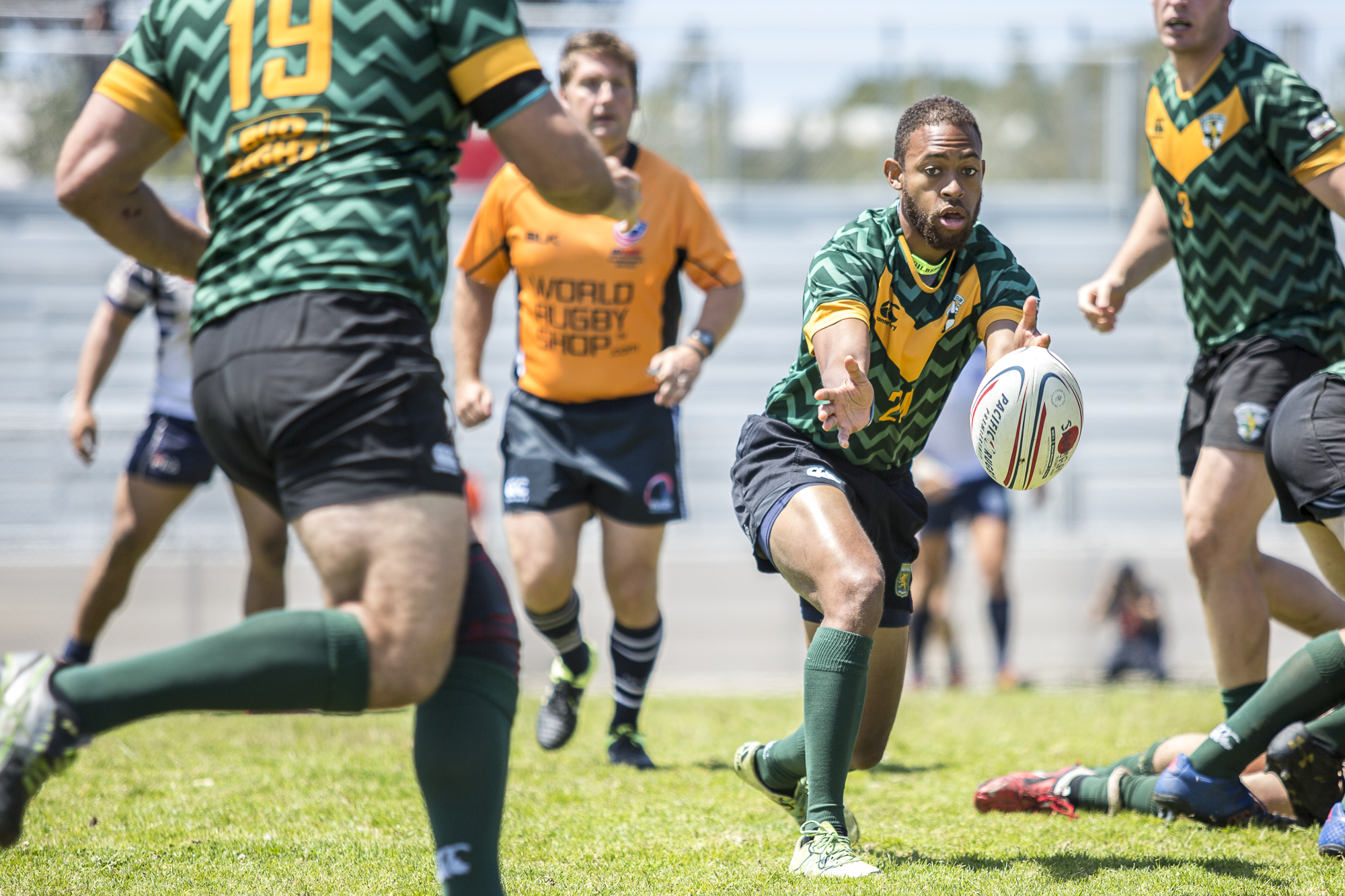  A Santa Monica Dolphin rugby back passes the ball to his teammate during the 2nd half of the game against the Old Mission Beach Athletic Club at Westchester High School in Westchester California on Saturday April 28 2018. The Santa Monica Dolphins w