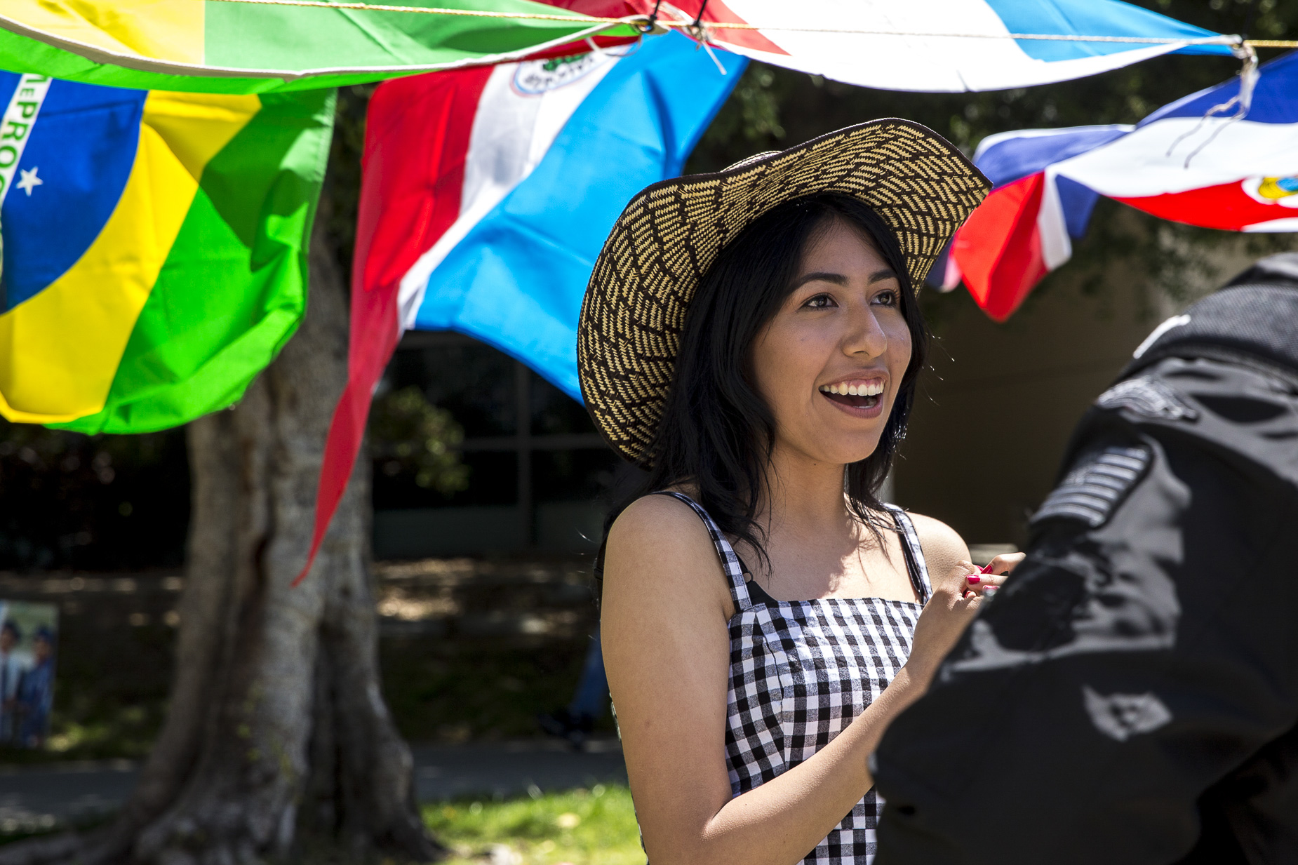  Santa Monica College (SMC) student and “Adelante” Club member Lesley Calvo interacts with students passing by the Cinco De Mayo celebration event that took place in front of the clock tower on the SMC main campus in Santa Monica California on Thursd