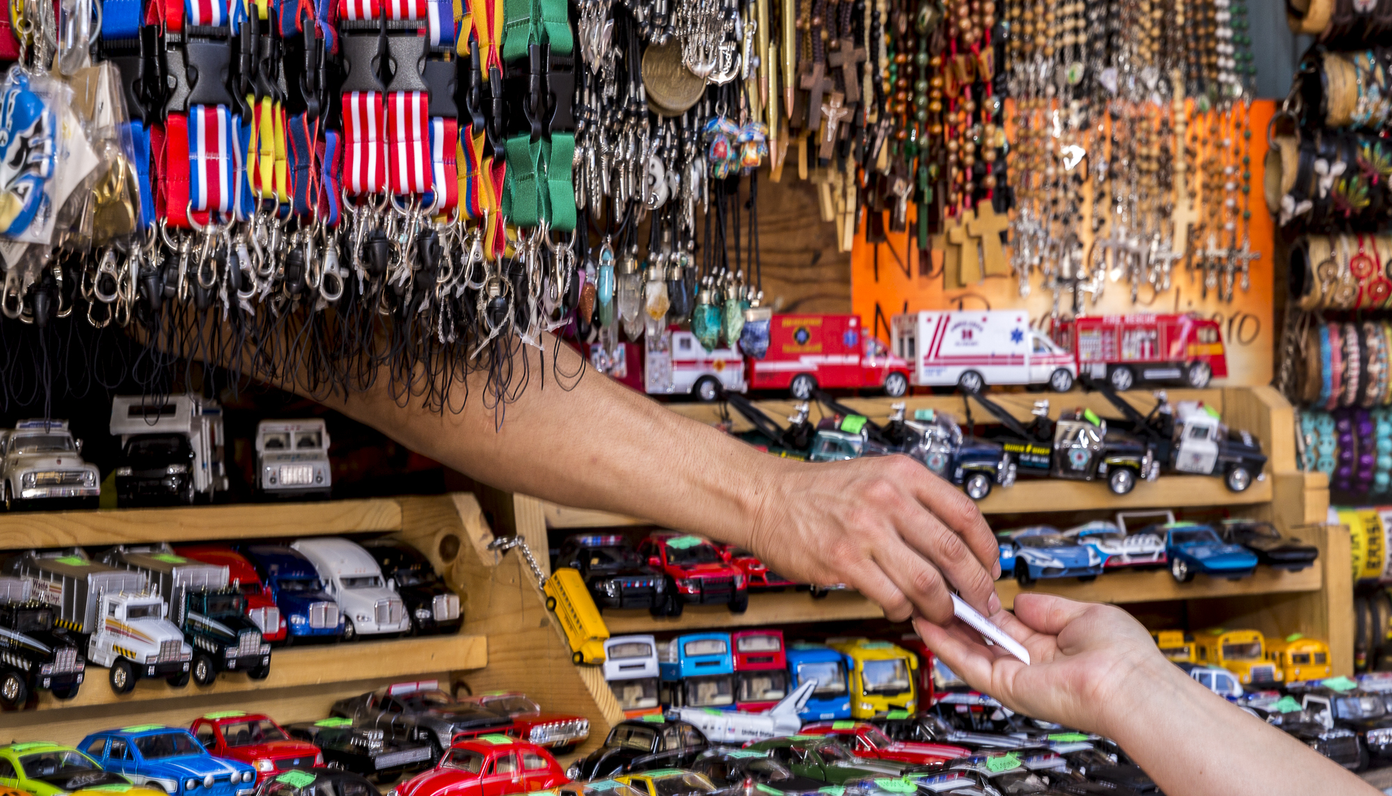  A hand appears out of one of the many stalls to give a receipt to a customer during the annual Olvera Street Cinco De Mayo celebration in Downtown Los Angeles, California on May 5, 2018. (Matthew Martin/Corsair Photo) 