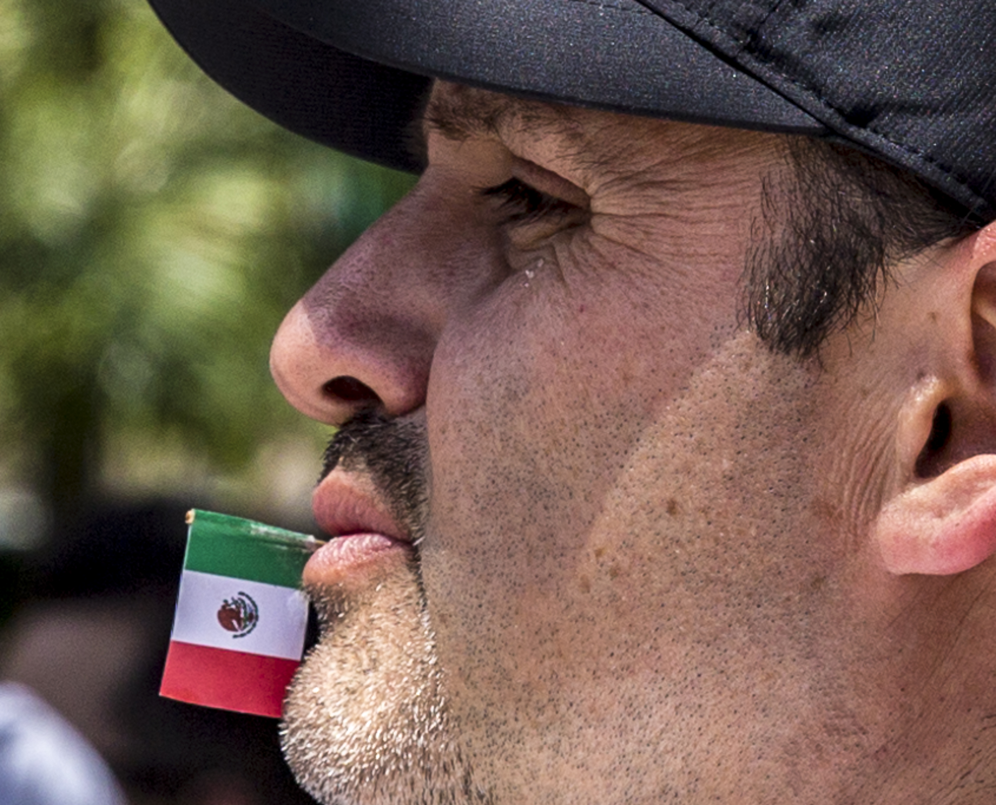 Manuel Garcia chews on a toothpick with the Mexican flag attached to the end of it during the annual Olvera Street Cinco De Mayo celebration in Downtown Los Angeles, California on May 5, 2018. (Matthew Martin/Corsair Photo)