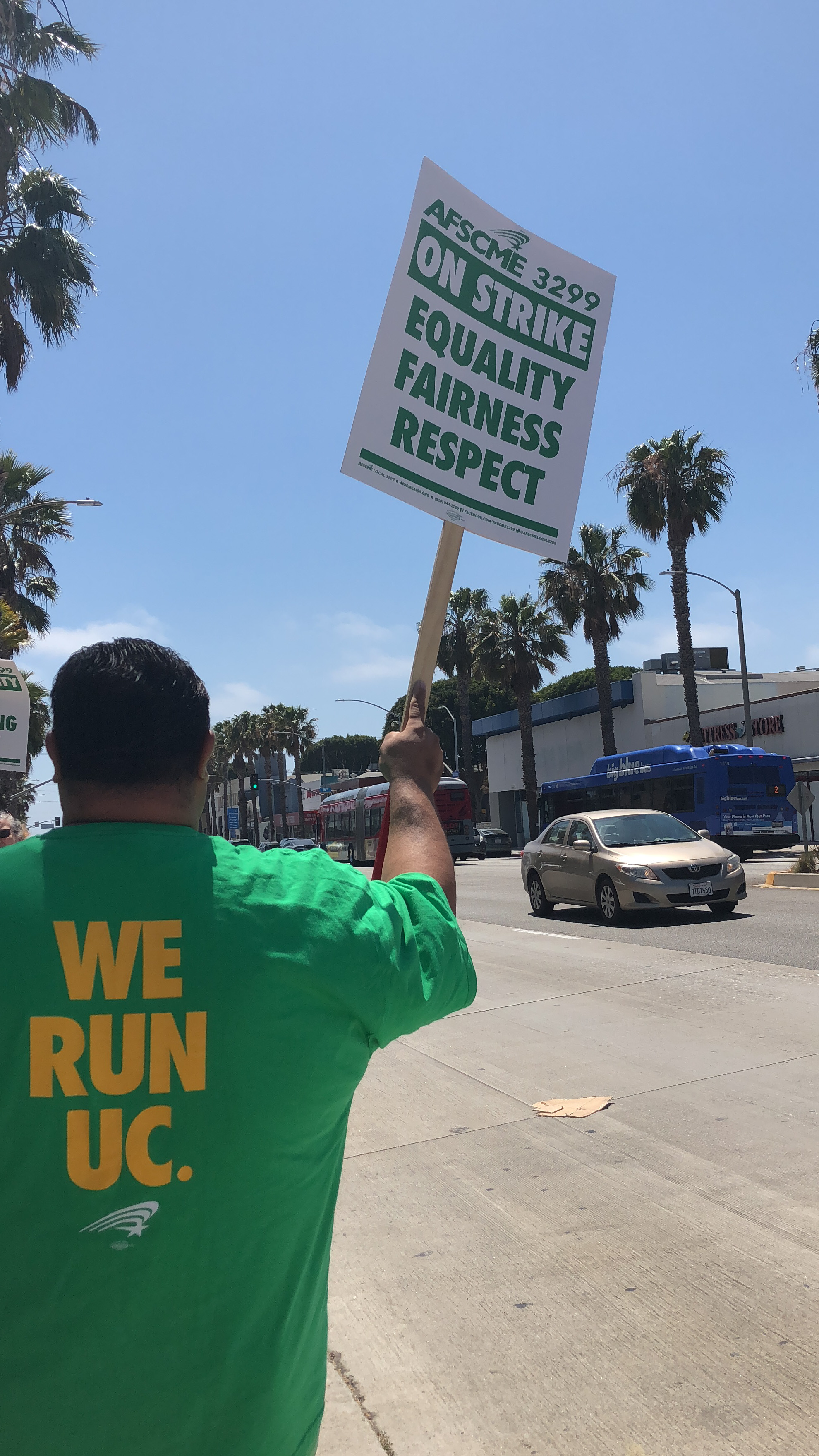  UC worker John Llanes stands on Wilshire Blvd with a picket sign in hand in support of a new contract from the UC system in Santa Monica, California on Monday, May 7th, 2018. (Ryanne Mena/ Corsair Photo) 