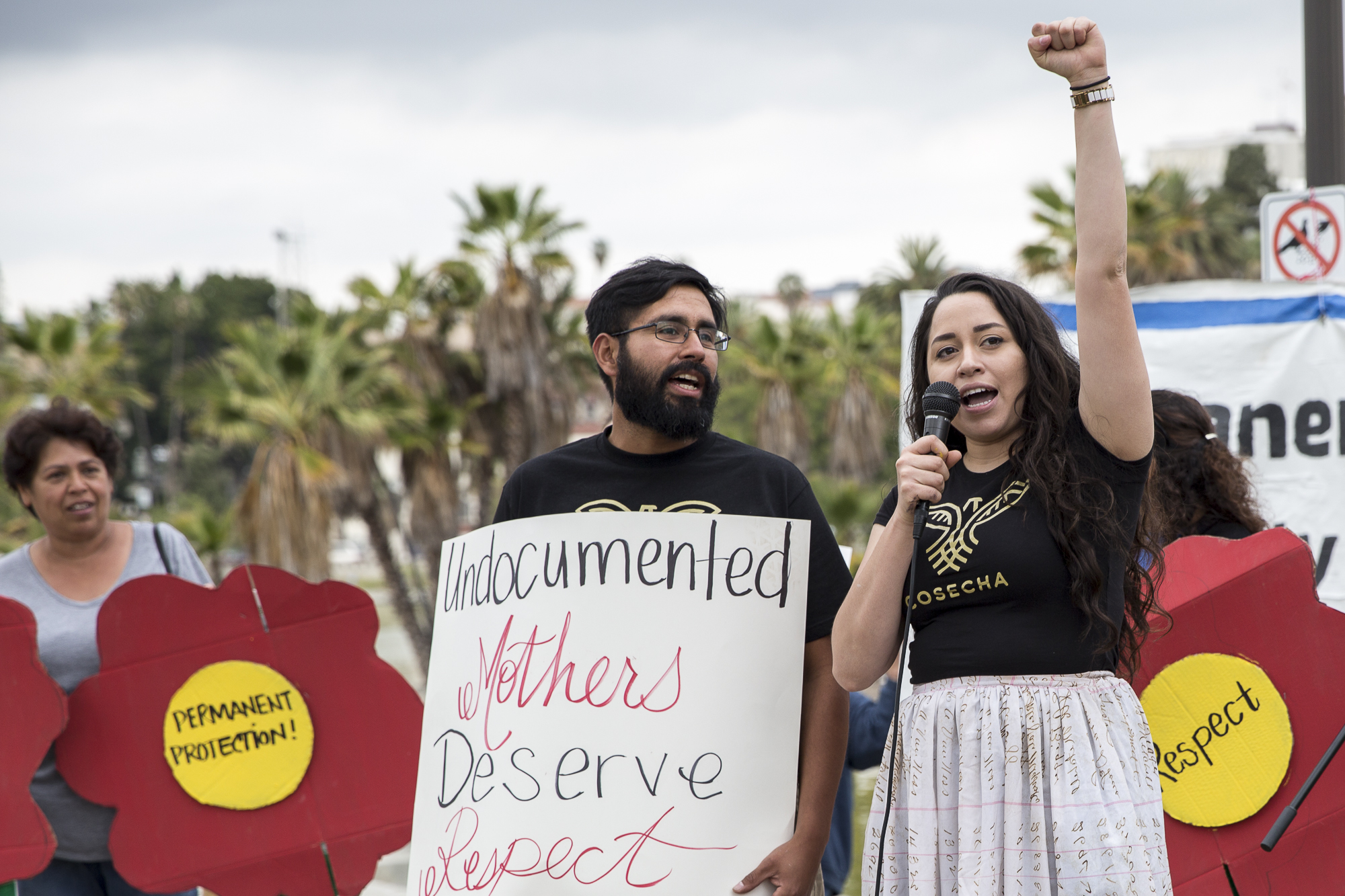  Movimiento Cosecha members and community organizers Robert Juarez (left) and Claudia Treminio (right) teach chants and songs to those that attended the undocumented immigrant mother’s rally that took place at MacArther Park in downtown Los Angeles, 