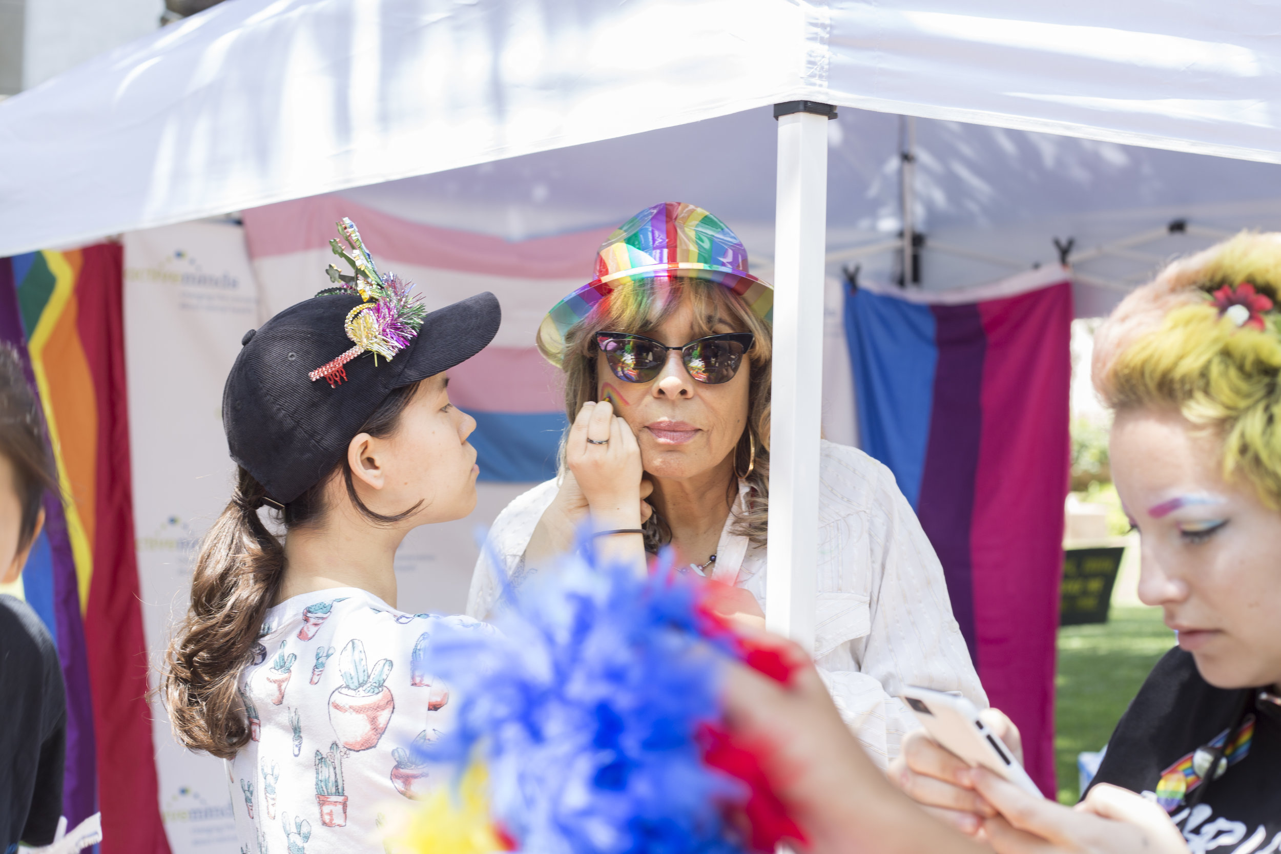Santa Monica College (SMC) pride week event. All of the spirit: Michele Harrison from Student Life getting her face painted. SMC main campus, Santa Monica, California. Tuesday May 15, 2018. (Fernanda Rivera, Corsair Photo)