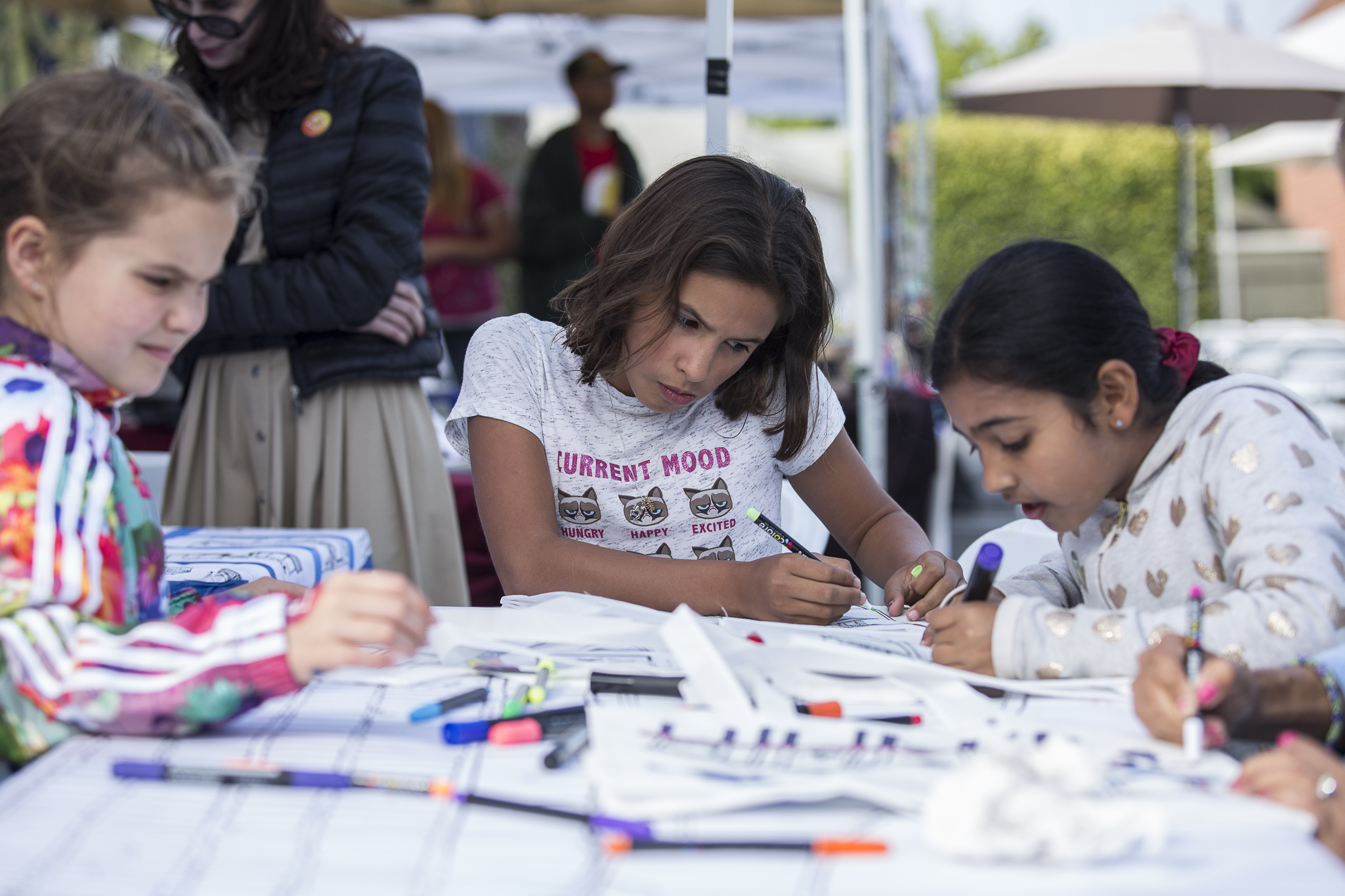  Santa Monica resident Bianka Henry (center) colors in a tote bag with a printed map resembling interesting locations in the Santa Monica area during the Pico Block Party festivities that took place at the 18th street Arts Center in Santa Monica, Cal