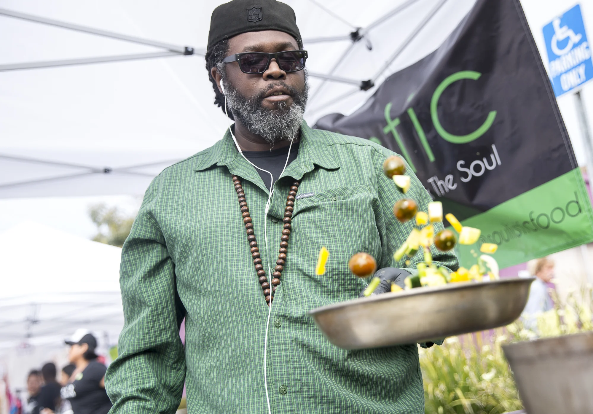 Chef D. Dahm tosses a mix of vegan ingredients in a pan at the “Soulistic Vegan Food” tent during the Pico Block Party festivities that took place at the 18th street Arts Center in Santa Monica, California on Saturday May 19, 2018. The Pico Block Party is a celebration of artists and cultures of the Pico neighborhood in Santa Monica with the festivities primarily focusing on youth artists and empowering youth voices. (Matthew Martin/Corsair Photo)