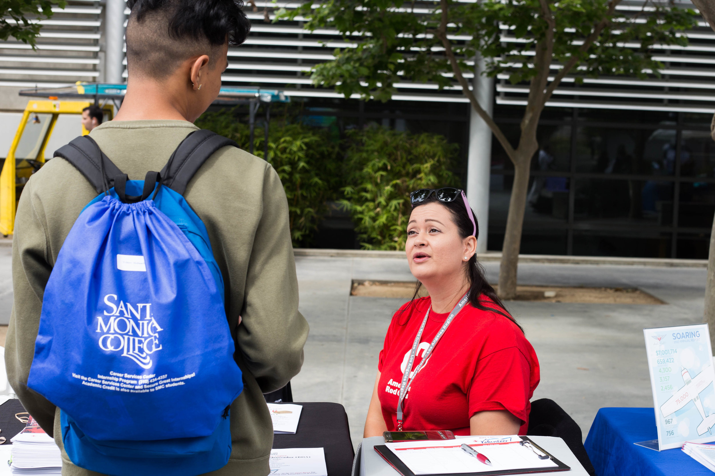 Santa Monica College (SMC) Internship Fair: American Red Cross Table., Ana Ramirez, Volunteer Recruitment Representative talking to a SMC student. SMC main campus. Santa Monica, California. Tuesday May 22. (Fernanda Rivera/ Corsair Photo)