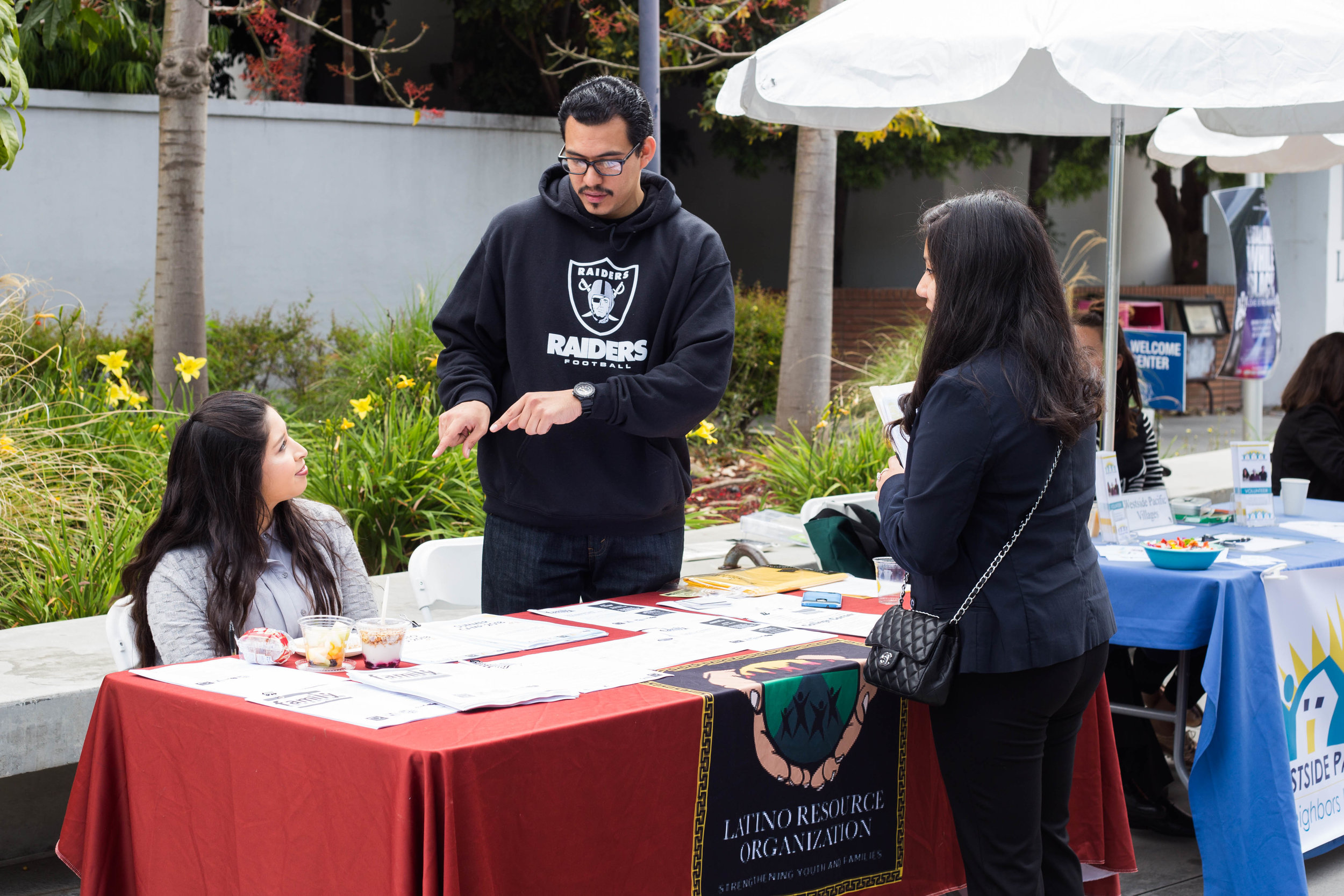  Santa Monica College (SMC) Internship Fair: (right) Isai Madrid, Youth Coordinator at West Los Angeles Family Source Center-Latino Resource Organization, and (left) Adriana Garcia, talking to a SMC student about their goals at the organization. SMC 