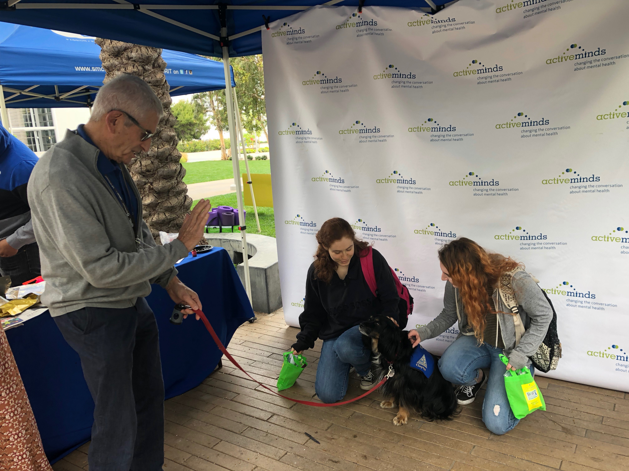  Bob Cowan with Paws for healing brought along dog Clayton to say hello at Active Minds event on Thursday May, 24 at Santa Monica College, in Santa Monica, California. Here with students Madeline Samson (left) and Skyler Stark (right). (Jennifer Nyst