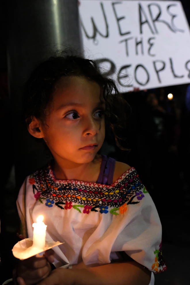  A little girl holds a vigil candle during the Justice for Claudia Vigil in Los Angeles, California on Saturday June 1, 2018.(Jayrol San Jose/Corsair Contributor) 