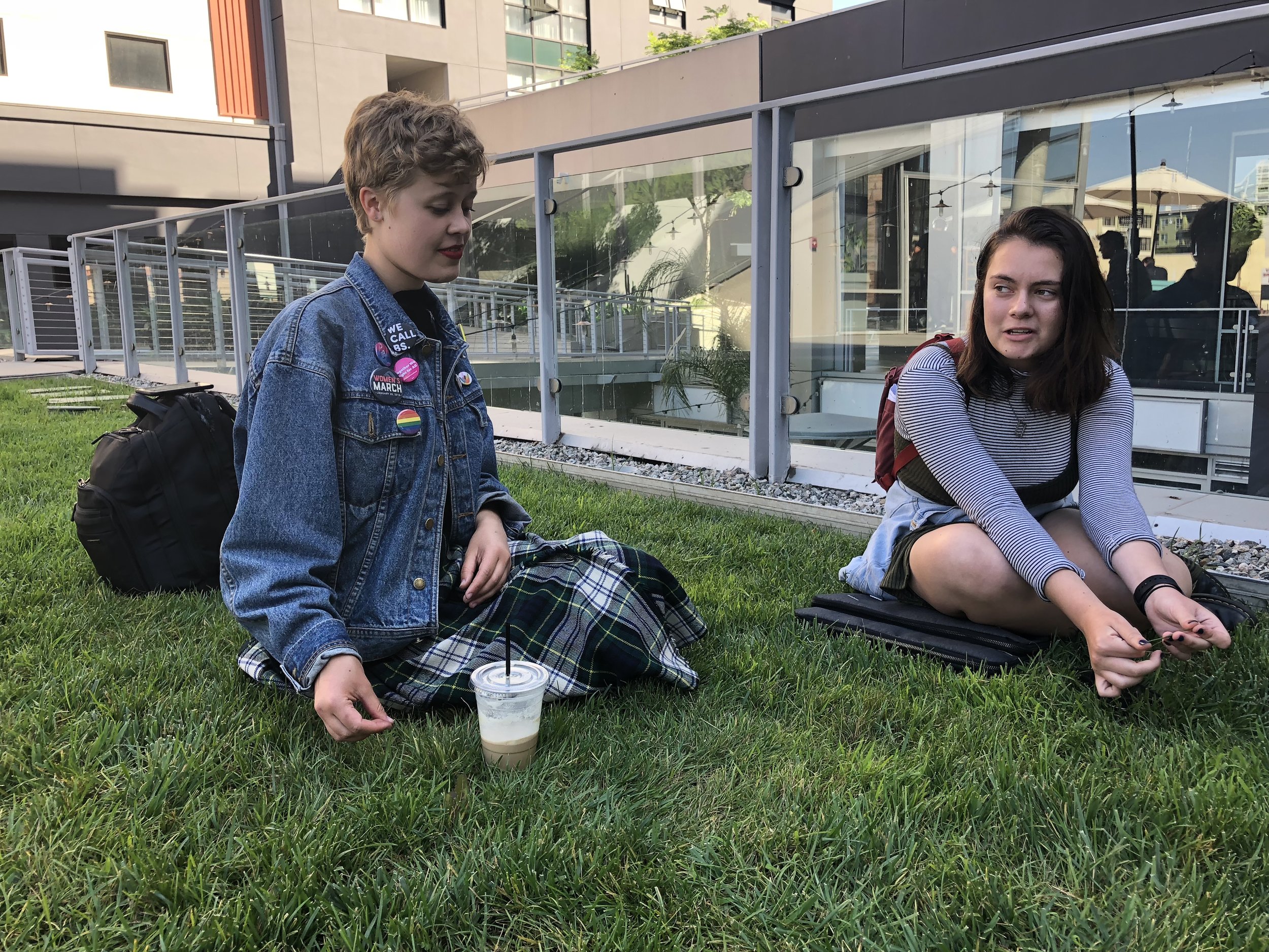  Oona Wuolijoki (left) and Amanda Southworth (right) sit on the grass outside of Tilt Coffee Bar as they discuss their plans for the upcoming Die-In Protest in downtown Los Angeles, Calif. on Friday, June 1. (Ryanne Mena/Corsair Photo) 