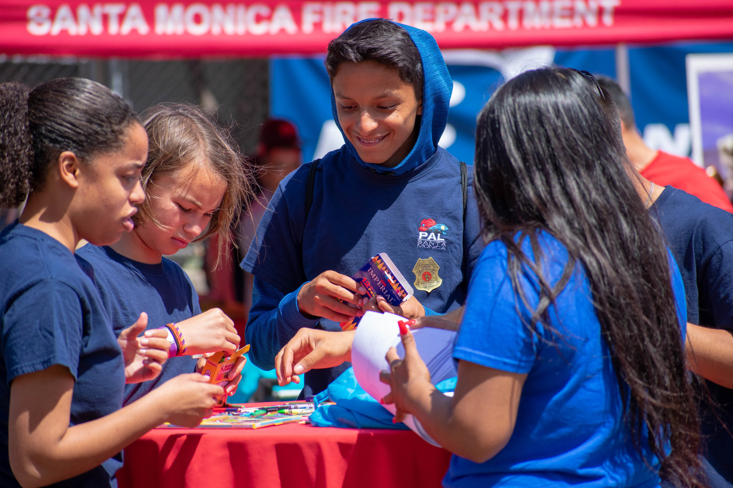  Jesse del Rio, center, a volunteer with the Police Activities League assists during a groundbreaking event in downtown Santa Monica on Saturday, June 2 at the location for the newest station. Located on 1444 7th St, the station will be replacing Fir