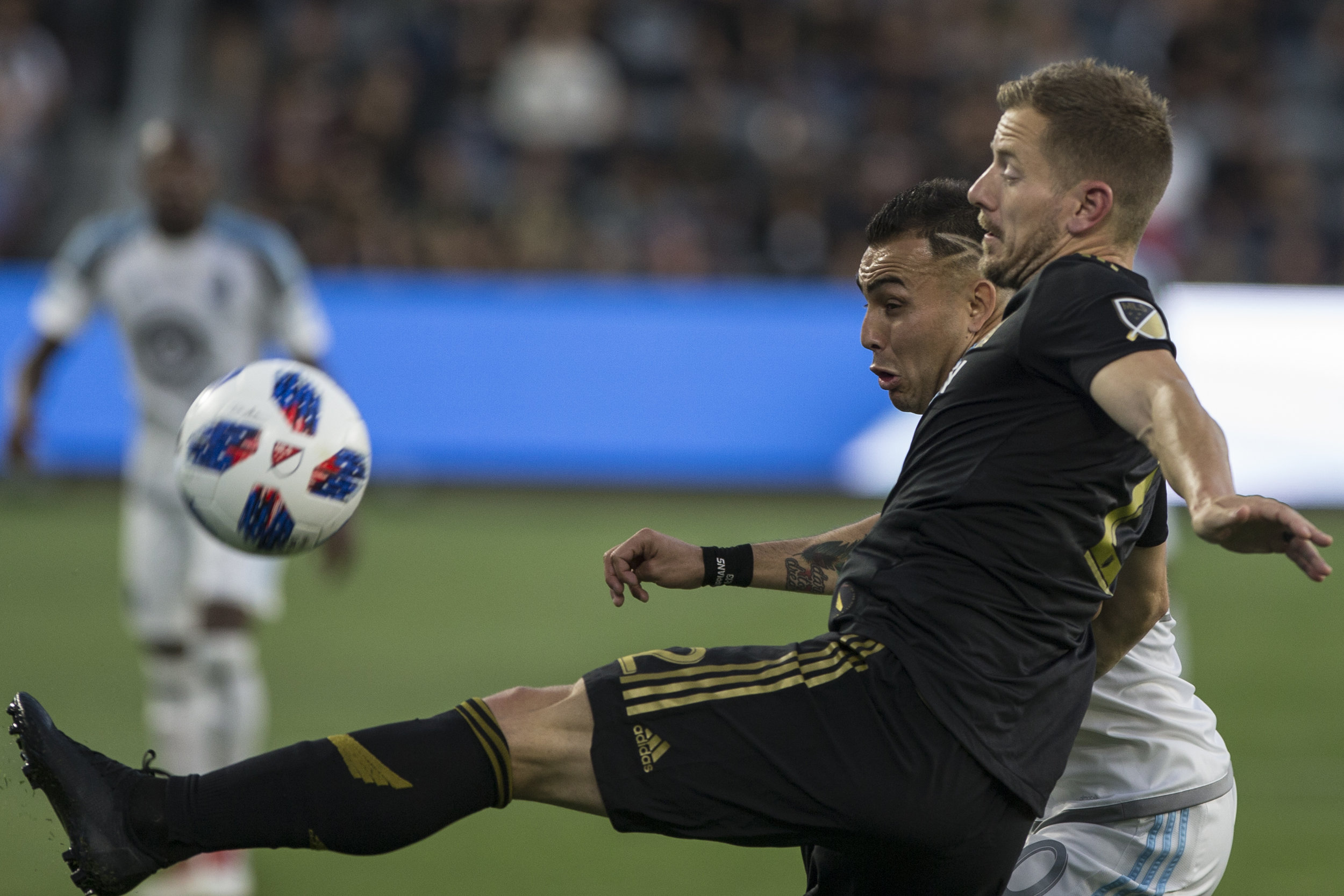  Los Angeles Football Club (LAFC) member Jordan Harvey (front) keeps the ball away from Minnesota United Football Club (MUFC) midfielder Miguel Ibarra (back) during their match at Banc of California Stadium on May 9, 2018 where the LAFC won 2-0. (Zan