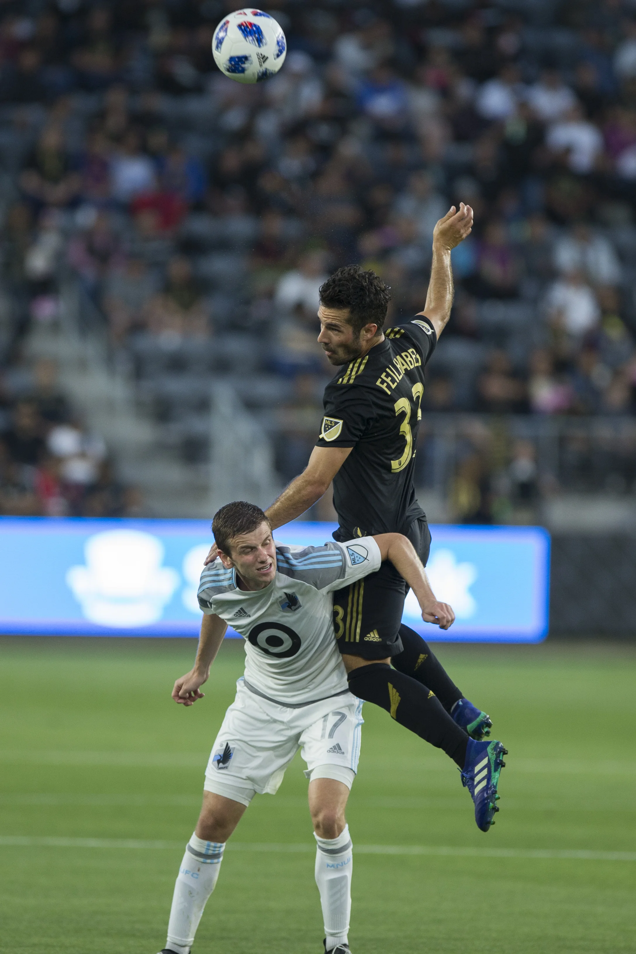 Minnesota United Football Club (MUFC) midfielder Collin Martin (17, left) headers the ball away from Los Angeles Football Club (LAFC) midfielder Benny Feilhaber (33, right) during their match at Banc of California Stadium on May 9, 2018 where the LAFC won 2-0. (Zane Meyer-Thornton/Corsair Photo)