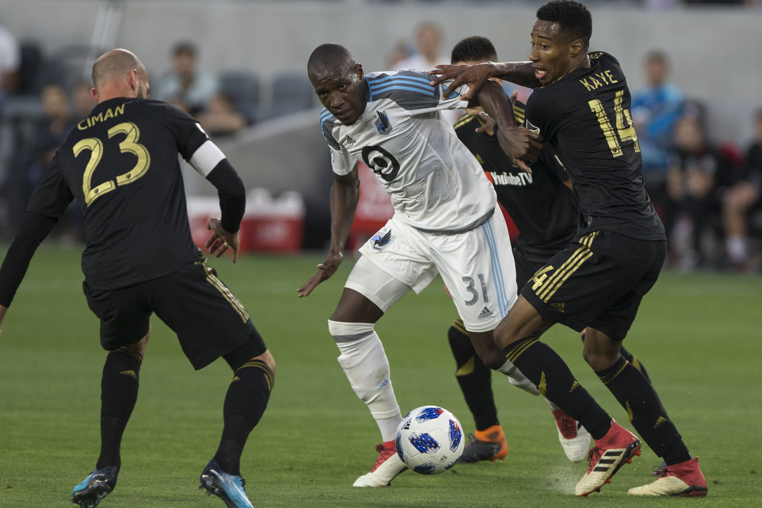  Minnesota United Football Club (MUFC) midfielder Maximiniano (31, middle) battles for control of the ball against Los Angeles Football Club members Laurent Ciman (23, left) and Mark-Anthony Kaye (14, right) during their match at Banc of California S